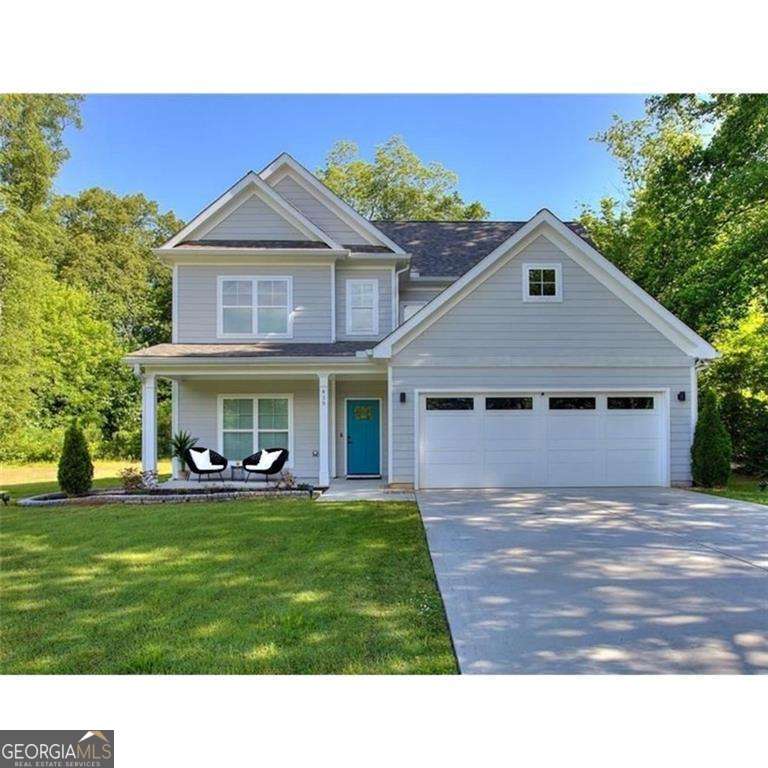 Introducing a beautifully maintained, like-new home in the desirable Smyrna/Marietta area, quietly nestled on a cul-de-sac street. Built just three years ago, this craftsman-inspired residence features a functional and stylish layout with a separate dining room, engineered luxury vinyl plank flooring throughout the main level, and an open-concept kitchen outfitted with quartz countertops, stainless steel appliances, and an upgraded waterfall island. The adjoining family room with a cozy fireplace offers generous space for both relaxation and entertaining. Double doors lead from the main living area to a covered patio-perfect for outdoor dining or lounging-overlooking a level, landscaped backyard. Upstairs, the owner's suite provides a peaceful retreat complete with a beautifully appointed en-suite bath featuring dual vanities, a garden tub, a tiled shower with glass doors, and modern fixtures. Two additional spacious bedrooms share a well-designed hall bath. The upstairs laundry includes a quartz countertop, tile backsplash and cabinetry to neatly store and conceal cleaning products. Thoughtful upgrades to lighting, hardware, and finishes further enhance the home's modern aesthetic. This impeccably maintained and move-in ready home is ideally located just minutes from the shops, dining, and events of Marietta Square and Smyrna Market. A rare find in an established neighborhood. Schedule your private showing today.