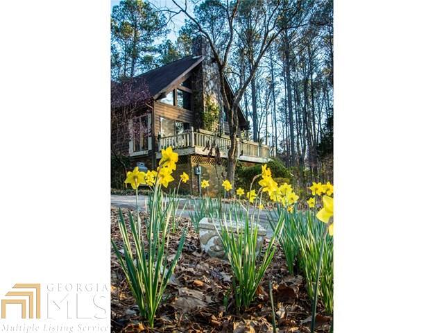 Welcome to your Mountain Cabin! Beaut Setting Nestled on 1.94ac Culdesac Lot! Estab Nhood! Impressive Vltd GR w/ Massive Rock FP that's Accentuated by Distinctive Tongue& Groove Ceiling w/ Exposed Cedar Beams! Sundrenched Kit w/ a Beaut Garden Window, Knotty Pine Cabinetry, Tile Countertops! Open & Airy! Efficient Roll-out Windows Thruout! Enjoy Reading/Relaxing in Loft Area leading to a Private Mstr Suite! Fin Terrace-level is like 2nd home offering Perfect In-law Suite w/Full Functioning Kit, Fireside FR w/ Blt-in Bkcases, Open Dining, Full Bath,Guest BR & Lg Wkshop! Enjoy all Nature Offers on 2 Open Decks, Screened Porch & Walking Trails lined w/Dogwoods, Azaleas, Magnolia, CrepeMyrtle's & flowering perennials! Conv to Shopping/Schools/Atlanta/& Monastery