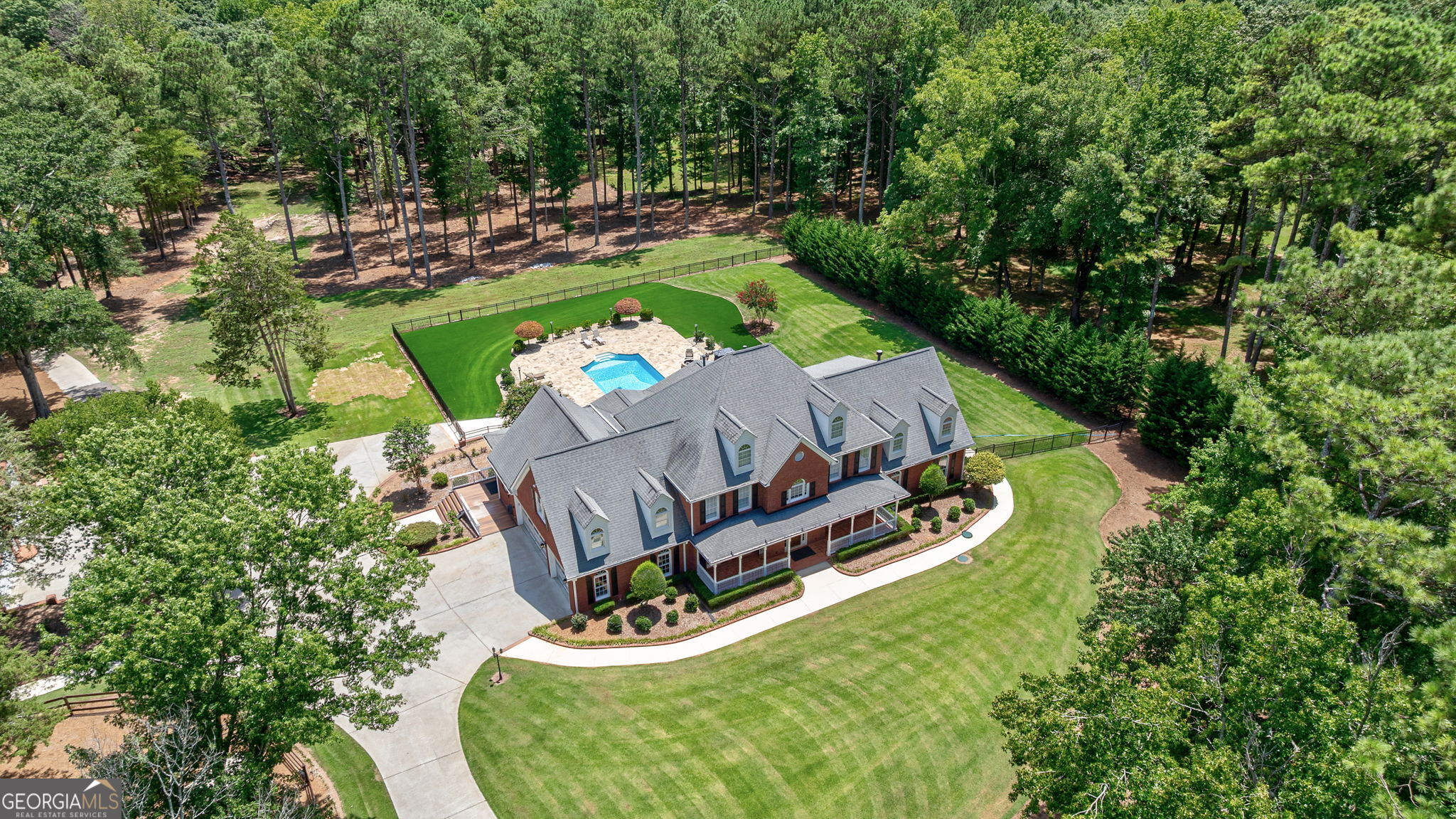 This CUSTOM-BUILT home in Walton County/Loganville on 8.5 ACRES on COVETED RABBIT FARM CIRCLE is just WAITING FOR YOU! THE GATED property is simply STUNNING and features a wonderful outdoor living area with a luxurious POOL & STONE FIREPIT, a fenced equestrian riding arena, a 50' X 60' OUTBUILDING/GARAGE perfect for that avid CAR COLLECTOR and includes a 1,200 SF upstairs room which could be utilized for guest quarters. Next door is an additional 30' X 60' multi-purpose building with retractable garage doors, lift station, wash station & RV PARKING. The beautiful SPRAWLING TWO-STORY 4-sided brick home is SO INVITING and the front porch WELCOMES YOU! The 5 BEDROOM & 4 BATH (3 HALF BATH - One on each level) home is a perfect mix of OPEN CONCEPT in the main living area and the FULL FINISHED BASEMENT, with TONS OF NATURAL LIGHT, NEW beautiful wood flooring throughout and large secondary rooms! The family room features a BEAMED CEILING and a brick fireplace and flows so nicely into the UPDATED KITCHEN, perfect for entertaining friends and family! The kitchen includes tiled flooring, granite countertops, tiled backsplash, stainless appliances, a separate breakfast area, breakfast bar and a desk nook. The MASTER SUITE is on the MAIN! It has nice arched windows, a double-sided fireplace shared with the master bath and is spacious enough that a NICE CLOSET SYSTEM would fit perfectly along the main wall. The MASTER BATH features HIS & HER VANITIES, marble countertops, a soaking tub to relax in after a long hard day and a tiled shower. Also on the main level is an AT-HOME OFFICE, an elegant dining area to host dinner parties, a HUGE laundry room/MUDROOM with cabinets and utility sink, and a half bath for guests. The secondary level includes 3 LARGE ADDITIONAL BEDROOMS & 2 FULL UPDATED BATHS and a half bath. Also included is a 2ND FAMILY ROOM/BONUS for the kiddos or a MULTI-PURPOSE ROOM. The FULL FINISHED BASEMENT will WOW you! You don't have to be a GEORGIA FAN, but if you are, you will LOVE it even more. SO much fun to be had including an entertainment area with a brick fireplace, a BAR, a FULL BATH to be used after you come in from the pool or for bathing the fur babies, TONS OF STORAGE and an additional garage. The basement leads directly out to the POOL, with a beautiful sprawling patio for grilling. The exterior of the home also includes FIBERGLASS/PVC decking which extends the whole length of the back of the home and overlooks the pool area. JUST BREATHTAKING! Perfect for the morning coffee. Your DREAM HOME AWAITS YOU!