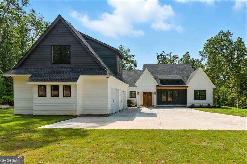 Welcome to this stunning new construction Modern Farmhouse nestled on 3 private acres in Canton, just off Hwy 20. Designed for both comfort and style, this ranch-style home offers 5 spacious bedrooms, 4.5 baths, and an open floor plan perfect for entertaining. The heart of the home features a gourmet kitchen, seamlessly flowing into the living and dining areas, creating the ideal space for gatherings. Step outside to your expansive outdoor living area, perfect for relaxing or hosting guests in your serene, private oasis. This home is truly made for entertaining, with thoughtful touches like a walk in pantry, a convenient laundry room connected to the owner's suite, and a bonus room above the garage that's perfect for a home office, playroom, or extra guest space. Located on a quiet street, you'll enjoy peace and privacy while still being close to everything - top-rated schools, shopping, and Veteran's Park are just minutes away. Don't miss the chance to make this beautifully crafted farmhouse your forever home!