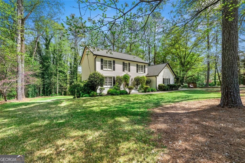 LOCATION! LOCATION! LOCATION! Don't miss this Smoke Rise North home located in the AWARD-WINNING Parkview district (Camp Creek Elementary). Nestled on a private 1.13 acre lot with an expansive level yard and an extraordinary finished terrace level. This beautiful MOVE-IN-READY 4BR, 3BA updated basement home is set back from the street, boasting a deep front yard, and a BRAND NEW 450 SF modern deck overlooking over 10,000 SF of lush Meyers Zoysia grass. This is truly the perfect home for entertaining or just relaxing. The first level includes formal dining & living rooms, family room and a reimagined kitchen with updated countertops, backsplash, WP appliances and a large breakfast area. A versatile bedroom & full bath-ideal as a guest room, home office, or main-level bedroom. Hardwood flooring & recessed lighting throughout. The second level features a primary suite with en-suite bath + 2 additional bedrooms sharing a full bath with upgraded bathtubs, showers, and custom cabinetry. Don't miss the recently finished basement with beautiful tile flooring, two flexible rooms (bedrooms, gym or office), large entertainment area, ample storage and potential for a future bathroom and wet bar. Enhanced Infrastructure: Newer roof, fresh exterior and interior paint and an upgraded garage. Don't miss the walk-out access to the backyard. This home seamlessly blends modern amenities with timeless charm in a highly desirable location with easy access to Emory University & CDC (12 mi), CHOA Hospital (13 mi), downtown Atlanta (17 mi) and Hartsfield Int'l Airport (28 mi), offering a perfect balance of privacy and convenience. Just 3 miles to the swim, tennis and golf course at Smoke Rise Country Club. Centrally located to multiple soccer fields (GSA and TYSA). Camp Creek ES features a popular DLI program. Call today to schedule yours!