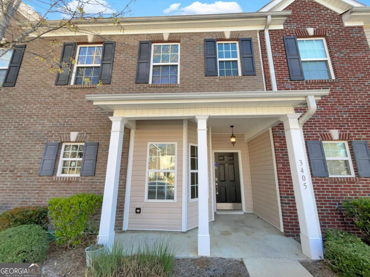 Enjoy modern living in this well-maintained gated community featuring a pool and convenient access to Atlanta Hartsfield-Jackson Airport and a variety of shopping and dining options. The home offers an eat-in kitchen with solid surface countertops, stainless steel appliances, and a pantry. The open-concept dining and family rooms create an inviting space for everyday living and entertaining. Upstairs, the roommate-style floor plan provides added privacy with each bedroom featuring its own full bathroom and walk-in closet. A dedicated laundry room is also located on the upper level for added convenience. Step outside to a private patio, perfect for relaxing or entertaining. The HOA includes water, landscaping, termite control, and garbage services, offering worry-free maintenance and a beautifully kept neighborhood.