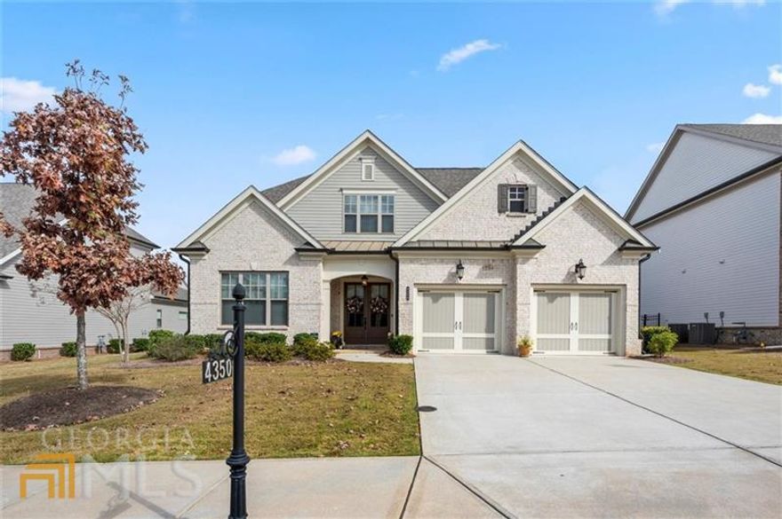Like new, move-in ready, open floor plan, shows like a decorated model! In sought after Traditions neighborhood in highly acclaimed Forsyth County schools (and taxes), neighborhood sidewalk accessible to the Forsyth Greenway and Fowler Park, minutes to shopping and dining at The Collection, Halcyon, and Vickery Village. Master suite on the main, with dual vanities, deep soaking tub, and seamless glass shower in master bath. Four bedroom plan, with one of the two other BR's on the main converted to home office with daybed, easily convertible back if needed. Two full baths plus half bath on main level. Kitchen has S/S appliances, double oven, built-in microwave, beautiful quartz countertops and large kitchen island, with open view to the family room with fireplace, and open formal separate dining room. Screened porch off the family room. Upstairs features large bonus room/playroom/workout room, plus a large upstairs bedroom and full bathroom with double vanities, tub/shower, and three unfinished walk-in storage rooms/areas upstairs. HOA includes lawn maintenance, community clubhouse, swim/tennis, playground, and workout area. Front porch entrance with paned wooden double doors. Owner improvements include shiplap in foyer, front hallway, and over fireplace wall, stone tile around fireplace, fenced back yard, screened in the porch, stone paver patio and landscaping by back porch, new chandeliers in foyer and dining room, new rain shower head in master, new paint interior. Seller cannot close before 12/22/22!