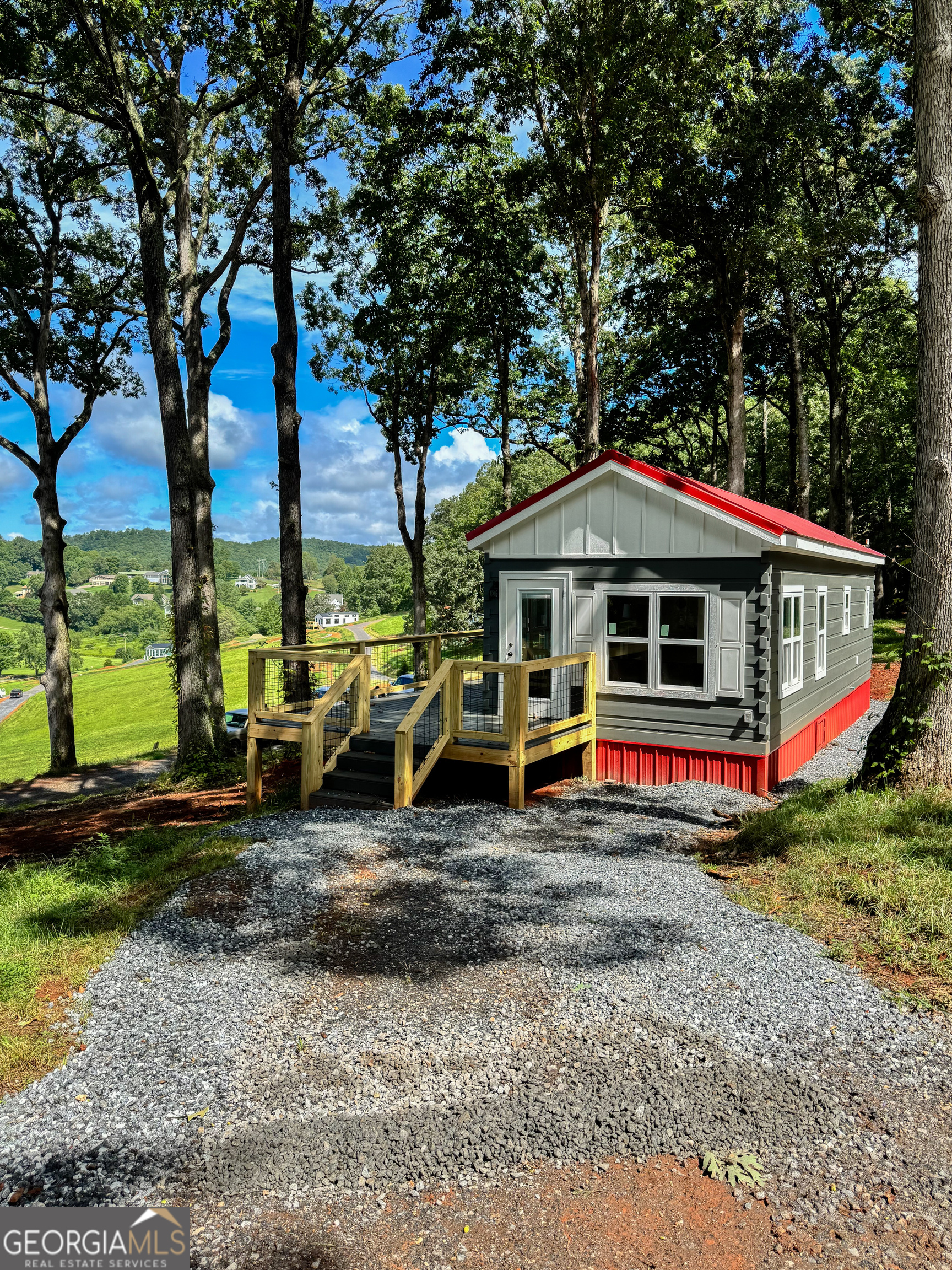 This turnkey Madison model tiny home is a 396 square feet, 14 x 40, 1 bedroom, 1 bath with office and sunroom RV park model. It is located on the 0.26 acre Lot #13 in Peaceful Meadows. Peaceful Meadows spans 28 acres and will feature 78 homes at completion. Residents enjoy a peaceful, community-oriented lifestyle with modern amenities including paved roads, water, septic, high-speed internet, and professionally maintained landscaping in shared green spaces. Future amenities under development include: * Gated entrances * Clubhouse with fitness room & pavilion * Picnic area * Pickleball court * Dog park Please note: Home is not available for occupancy until utilities are installed and final setup is complete-estimated move-in ready by early September 2025. Active construction site - use caution when visiting.