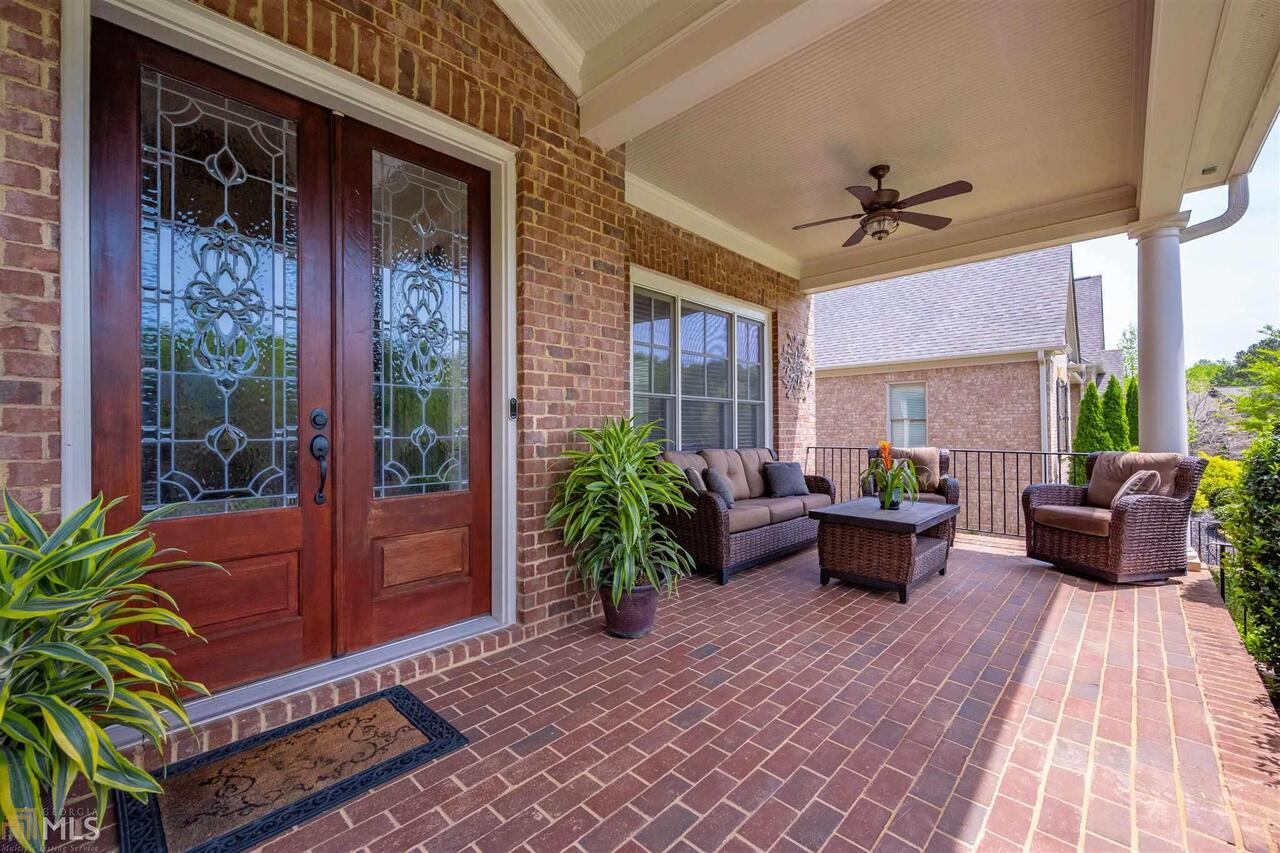 NEW LISTING in popular Greystone Manor community!  This 3.5 sides brick home features 7 bedrooms, 5.5 baths, a gorgeous terrace level, and 4 car garage … all on a .69 acre lot!!  Hardwoods throughout most of the main level and convenient mud room with a “drop” zone helps keep you organized when coming home.  Gourmet kitchen features stained cabinets, soft-close drawers, granite counters, a large island with extra seating, double wall ovens, gas cooktop, large pantry, stainless steel appliances, plus a keeping room with fireplace!  Coffered ceiling in the great room with built-in bookcases and a 2nd fireplace!  Dining room features a trey ceiling, beadboard trim, seats 12+, and includes a butler’s pantry.  Oversized master, large secondary bedrooms, and loft upstairs all feature brand-new flooring.  Baths are tiled and have granite counters.  Upstairs laundry room with a utility sink.  Gorgeous terrace level is an entertainer’s dream with a bar area, another walk-in pantry, media room, pool table, game area, and more!  Huge deck overlooks level, private backyard with an invisible fence.  Award winning Forsyth County schools.  Close to shopping, dining & more!