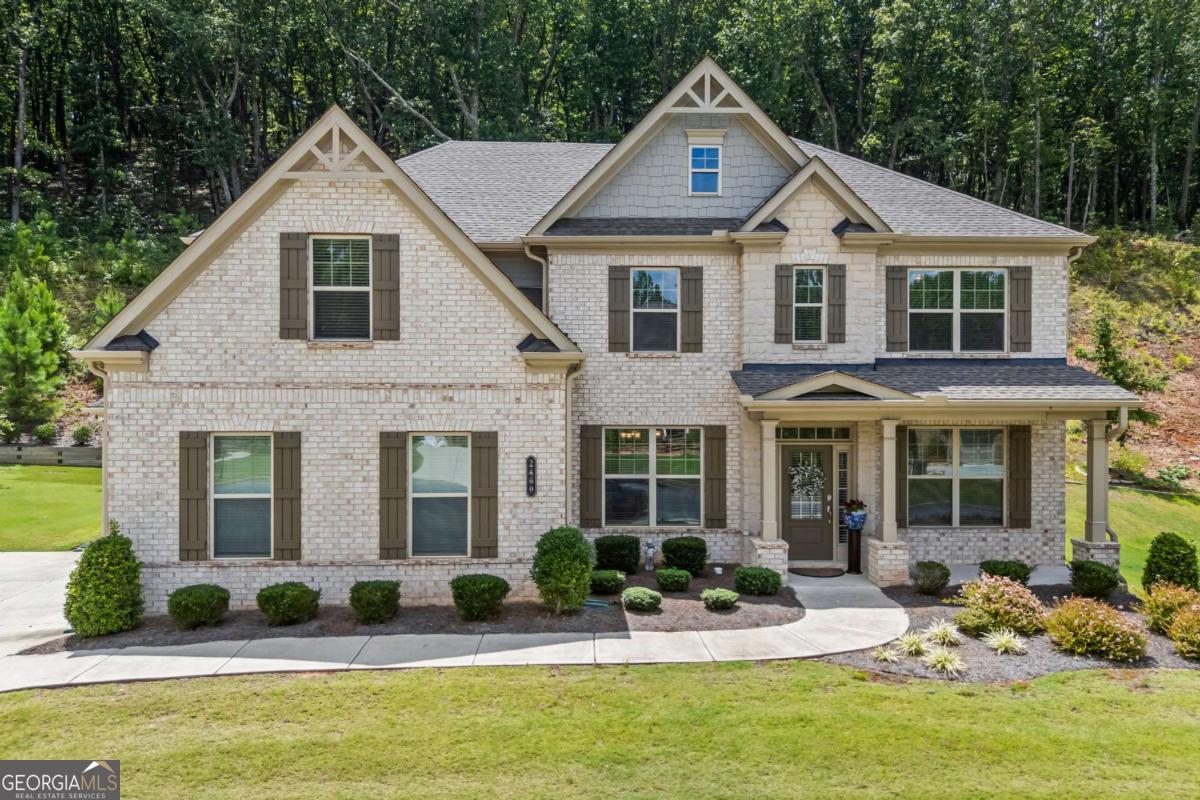 Welcome home! Located in a gated community with exceptional amenities, this 5 Bed / 4 Bath home offers over 3,800 square feet of thoughtfully designed living space on a spacious 0.51-acre lot. With three sides brick and a welcoming three-car garage this home has it all! Inside, you'll find an open floor plan perfect for hosting, a few features include cat walk overlooking the two story great room, two fireplaces, one located on the outdoor screened-in porch, elegant built-in bookshelves, hardwood floors throughout the home, and the main level includes a private bedroom. The family room features a convenient in-floor electrical outlet, and the flex room offers the flexibility to be used as a formal sitting area, piano room, or office. The gourmet kitchen flows seamlessly into the living and dining areas, while the oversized primary suite boasts a spacious sitting area, en-suite bathroom with tile shower, soaking tub, and a walk-through laundry room, adding both ease and efficiency to your routine. Additional upgrades include a gas hookup on the porch and a tankless water heater for on-demand hot water. Enjoy resort-style living with access to the community pool, splash pad, tennis courts, and more - all within the security of a gated neighborhood. Schedule your private showing today!