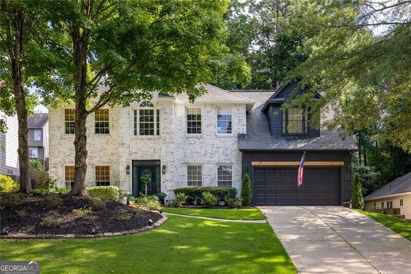 This updated classic blends timeless charm with modern touches, offering a layout designed for easy living and effortless entertaining. Inside, the main floor welcomes you with a soaring two-story foyer and 10+ foot ceilings throughout. A double-sided fireplace anchors two spacious living rooms, while the eat-in kitchen features upgraded appliances, generous counter space, and a sunny bay window overlooking the private backyard. Upstairs, the bright and peaceful primary suite boasts vaulted ceilings and a spa-inspired bath with a frameless shower, soaking tub, and eye-catching chevron-tiled accent wall. Three additional bedrooms share an updated hall bath, providing plenty of space for family, guests, or a home office. Step outside to a flat, walk-out backyard with a large patio-perfect for grilling, dining al fresco, or relaxing in privacy surrounded by mature trees. Located in a friendly swim and tennis community, you're just minutes from Avalon, downtown Alpharetta, and all your favorite spots.