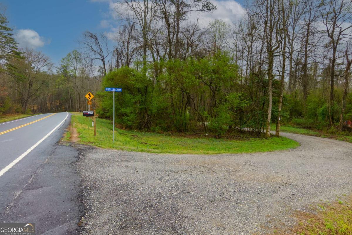 Discover your slice of North Georgia paradise on 10.03 acres, perfectly located just 5 miles from historic Dahlonega Square and the University of North Georgia. This property offers an ideal blend of privacy, convenience, and natural beauty, with several valuable improvements already completed. The land features a tree-cleared driveway and a gravel road bed, providing easy access to the heart of the property. A Level Three Soil Survey has been conducted on three potential build sites, making it even easier to envision your dream home, cabin, or retreat. Approximately seven acres of the property are bordered by Camp CreekCoa legitimate gold-bearing creek that feeds into the Etowah RiverCooffering a rare opportunity for gold prospecting, recreation, or simply enjoying the peaceful sounds of flowing water in your own backyard. Whether you're seeking a serene homesite, a recreational getaway, or a long-term investment, this tract offers unmatched potential. Despite its private, wooded feel, the property is just a short drive to major local destinations. It's located 7 miles from the end of Highway 400 and Northeast Georgia Regional Hospital, 10 miles from Dawsonville Square, and only 12 miles from the popular North Georgia Premium Outlets on GA 400. With its strategic location and natural charm, this is a property that truly stands out. The offering/price includes two adjoining parcels being sold together. For details on the second property, please refer to MLS #7556198.