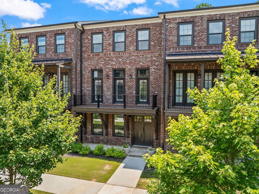Location, Location, Location. Step into this beautifully appointed, newer construction townhome offering refined living and timeless design. This home boasts hardwood floors throughout, an elevated appliance package, custom closets, plantation shutters, and comes complete with a refrigerator and washer/dryer-truly move-in ready. Enjoy a low-maintenance, lock-and-go lifestyle in an open, sunlit floor plan featuring soaring 10' ceilings and a seamless flow between the living, kitchen, and dining areas. The main floor also boasts 2 spacious decks for enjoying the courtyard and breezy days. The inviting gathering room centers around a statement fireplace, with views of the chef's kitchen. In the kitchen, you will find an abundance of cabinetry and an oversized island. The finished terrace level includes a private en-suite, ideal for guests or a home office. Every detail has been thoughtfully curated for comfort, function, and style. Ideally located just minutes from Whole Foods, top-tier shopping, acclaimed local dining, and within the highly rated Walton High School district. Easy access to Atlanta, Sandy Springs, Downtown Roswell, Marietta Square, I-285, I-75, and GA-400-only 20 miles from the heart of the city.