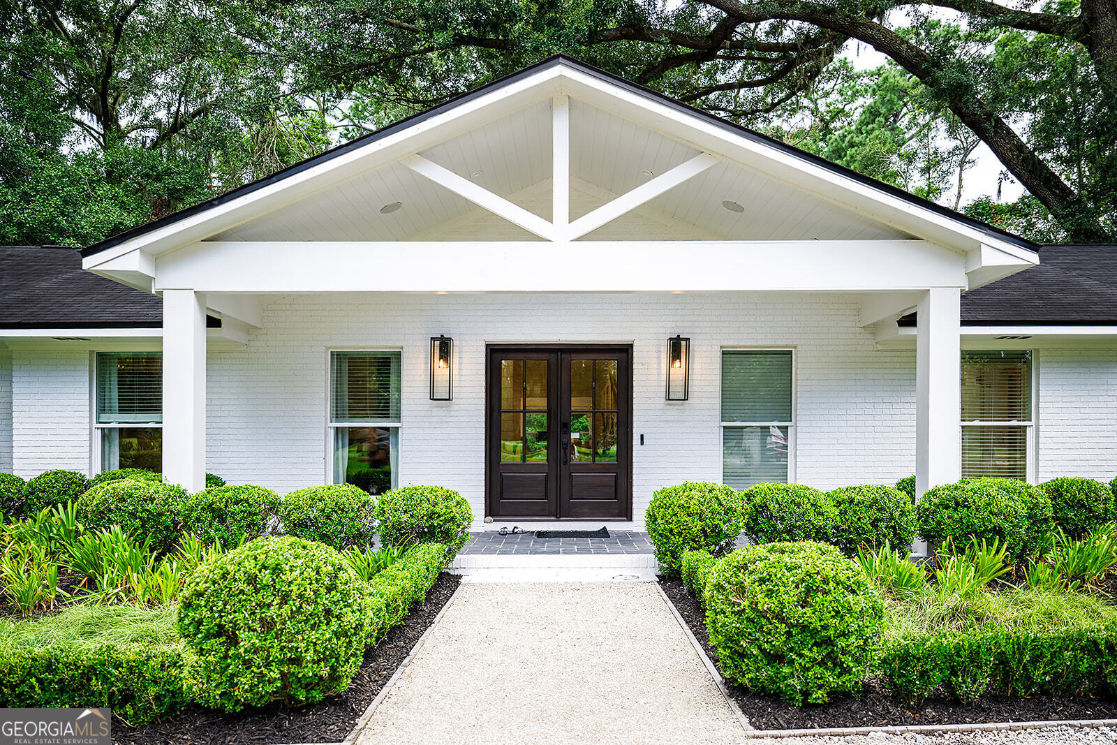 This stunning, professionally designed ranch-style home blends timeless charm with modern elegance. Fully remodeled with custom features throughout, every detail has been thoughtfully curated for both style and comfort. Offering 3 bedrooms and 2.5 bathrooms, the home includes a spacious separate laundry room and a garage for convenience. The chef-inspired kitchen boasts a beautiful butler's pantry-complete with a personal coffee machine-making mornings a delight. Open and inviting living spaces are enhanced with high-end finishes, designer lighting, and custom millwork. The primary suite features a luxurious ensuite bath with premium fixtures and a serene atmosphere, while the additional bedrooms provide comfort for family or guests. Perfectly positioned, this property sits along a picturesque lagoon with a golf course view in front, creating a unique blend of waterfront tranquility and green fairway beauty. Whether enjoying a peaceful sunrise over the water or watching golfers in the distance, the views are sure to impress. Move-in ready and brimming with custom touches, this home offers the best of St. Simons Island living-style, comfort, and unbeatable location.