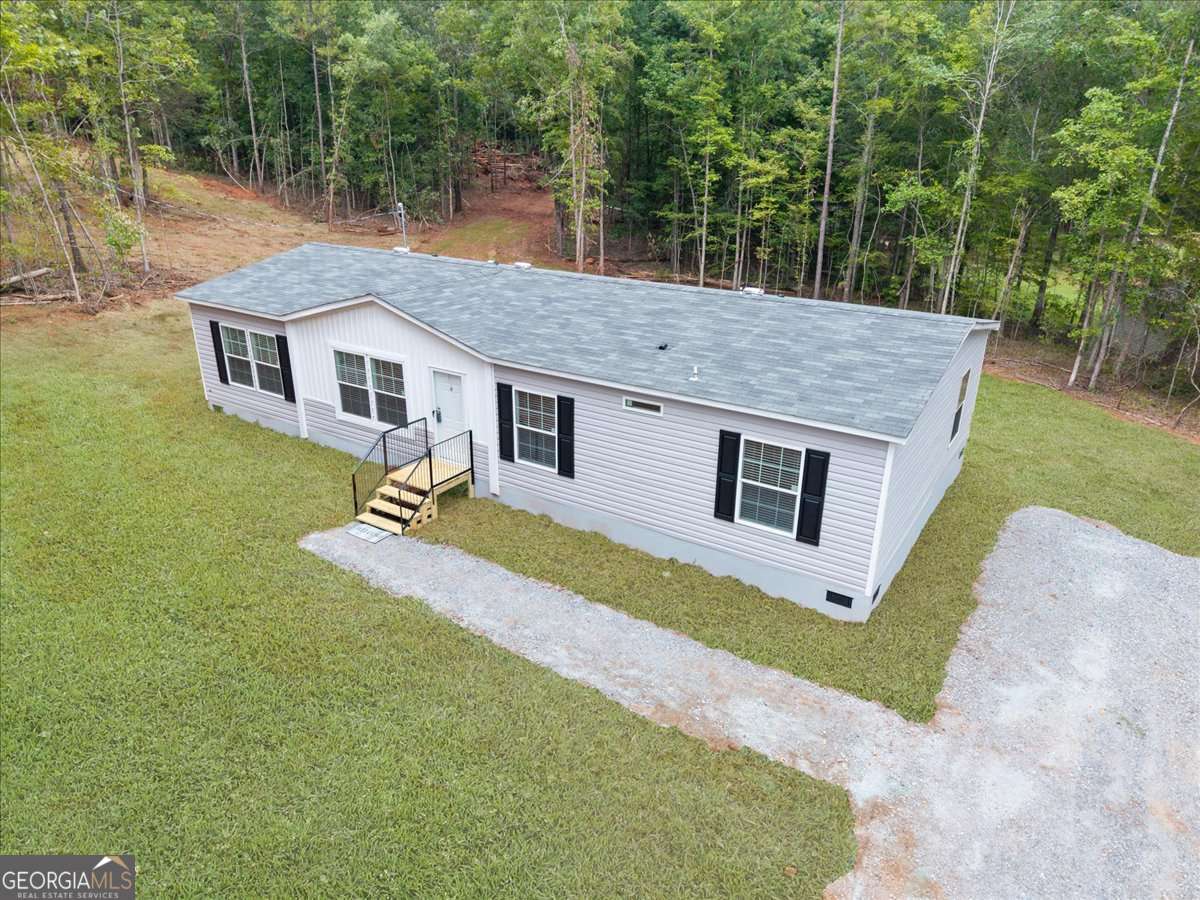 This beautiful NEW home has 4 bedrooms, 2.5 baths, with all the luxuries 1568 sq. ft, on a 1.80-acre lot. LVP flooring runs throughout the home making this an easy home to keep clean! This is a split bedroom floor plan - the primary suite is on one side and on the other side you have the 3 other bedrooms and bathroom. Step into the primary suite and discover oasis with its walk-in shower, separate soaking tub, and double vanity. Come home to relax after a long day of enjoying the nearby lake activities. The impressive kitchen, designed for both functionality and style. Has stainless steel refrigerator-freezer combo, oven and dishwasher. The large island is perfect for meal prep and entertaining. Separate dining room with French doors. Lake Sinclair Twin Bridge Marina Boat Ramp appx 3.5 miles away. You will love the privacy, appx 10 minute to Eatonton and Milledgeville amenities, and instant access to boating, fishing, and recreation. Located just minutes off of Hwy. 441 with a short commute from Atlanta, Macon, and Athens