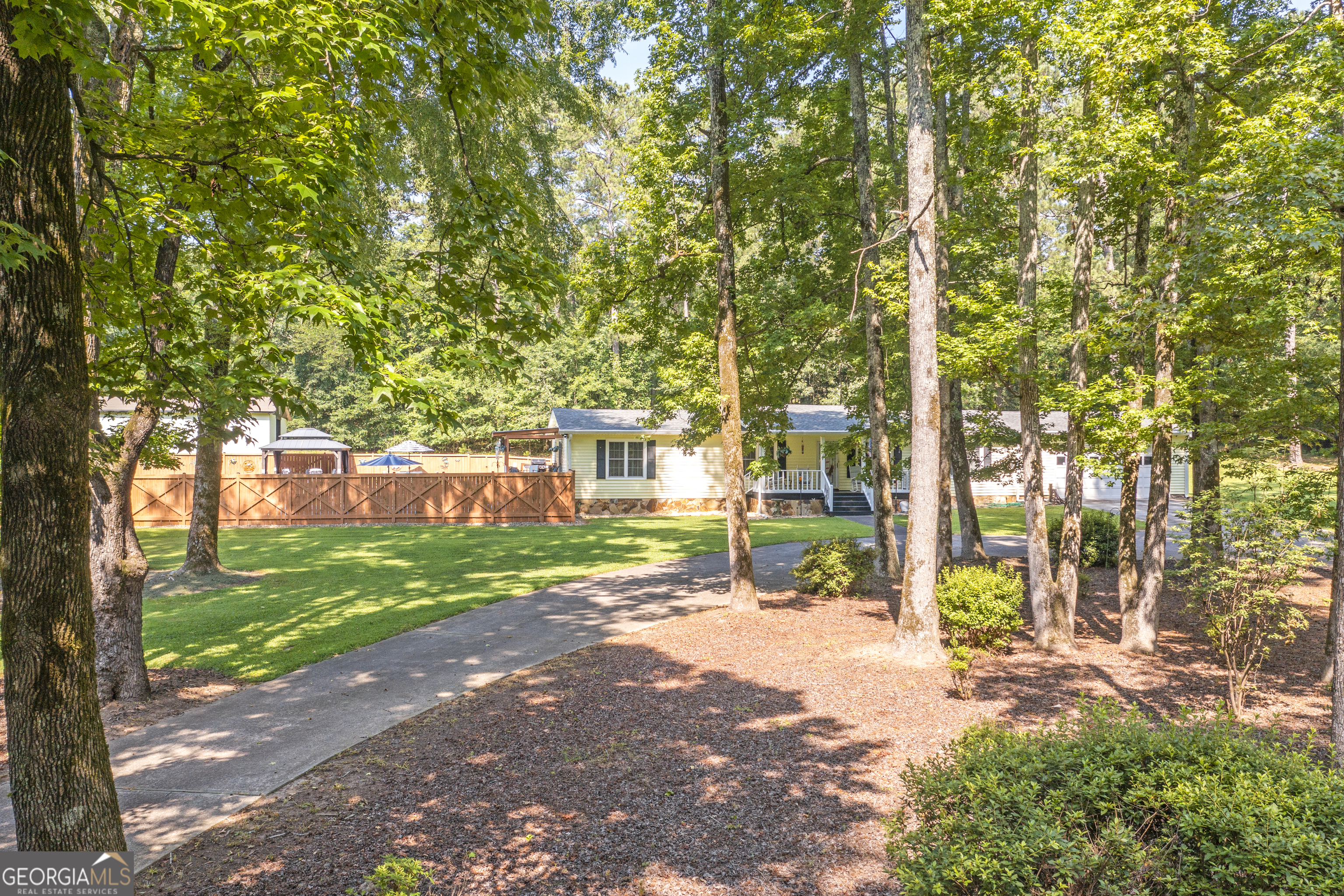 Beautiful, well maintained, 4 BR home, sitting on 2.4 acres in the prestigious Norris Lake community. Private fenced pool, huge 1600 square foot storage building with 40 X 8 parking pad. A beautiful level lot with trees galore. If you are looking for a home that is located in the suburbs but convenient to shopping, entertainment and the Big-City, (Atlanta, GA) then search no further. Norris Lake is not just another private community with a pool; the amenities include a 106.7 acre lake (great for fishing, boating, sailing, and jet-skiing!), a sandy beach, shaded beach with picnic area, parks, tennis courts, community garden, and a Junior Olympic-sized pool. One of a few lakes in the area, that allows motorized boats. New owner will have to apply for membership. Private pool @ the subject property has a multi-level patio, a professionally constructed stationary gazebo & a covered deck. Property has a 600' deep well with filtered water. A circular driveway, multiple parking spaces, & all the other facilities have allowed the current owners to host special events & large family gatherings. This home & large lot have many outstanding features with a quite country atmosphere. Thanks for showing, bring your best offer.