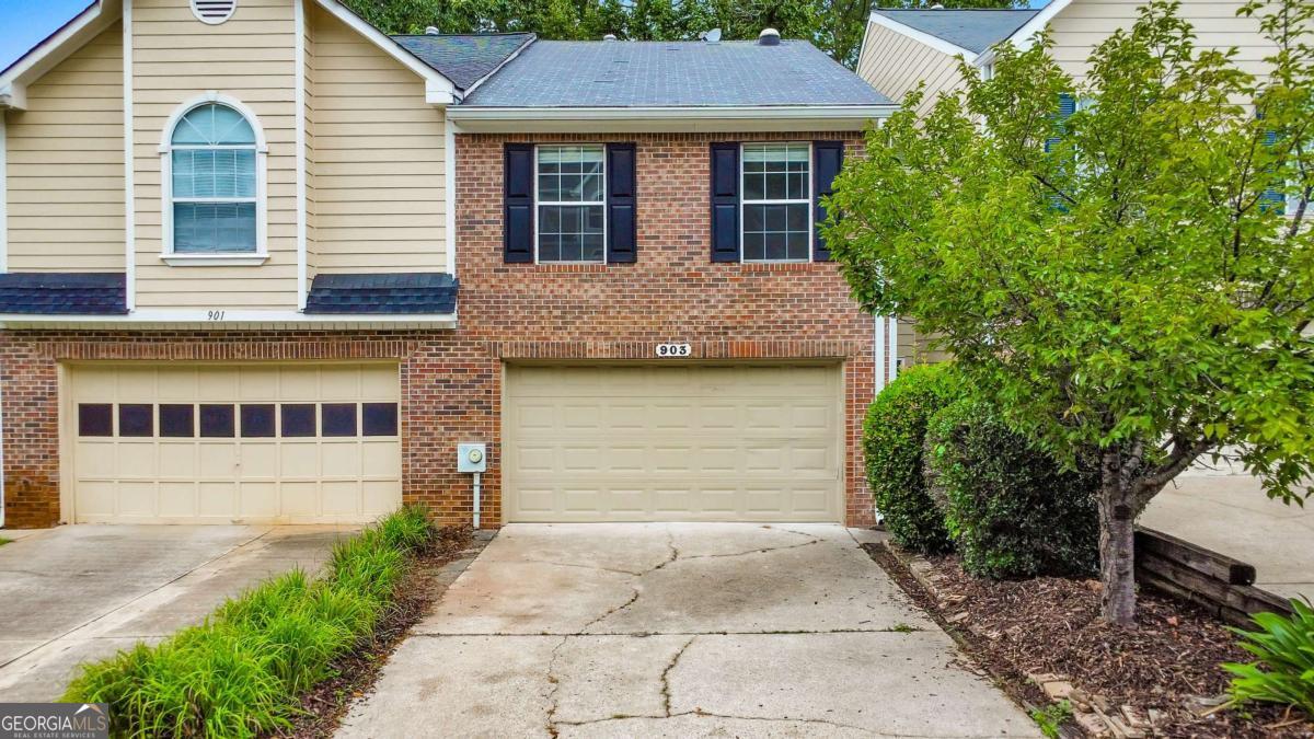 This timeless beauty is ready for you to move right in! Welcome to this elegant 2 bed / 2.5 bath townhome in East Cobb. Step inside to fresh interior paint, upgraded lighting, and a welcoming foyer that opens to a fireside living room with soaring ceilings and a skylight. The kitchen features granite countertops, a new sink, and updated cabinet hardware. Upstairs, a spacious loft offers the ideal spot for a home office or flexible living space. The primary suite includes an oversized walk-in closet and a beautifully updated ensuite with a double vanity, soaking tub, and separate shower. The secondary bedroom also enjoys the convenience of a private full bath. You'll find the laundry closet located upstairs, with the gas dryer included. Brand new carpet throughout the upper level. The back deck overlooks a peaceful pond that backs up to the Mount Paran Sports Complex. The Barnes Mill Lake community offers common area/yard maintenance, trash pickup, and trails for enjoying the outdoors. Don't miss your opportunity to make this delightful home yours!