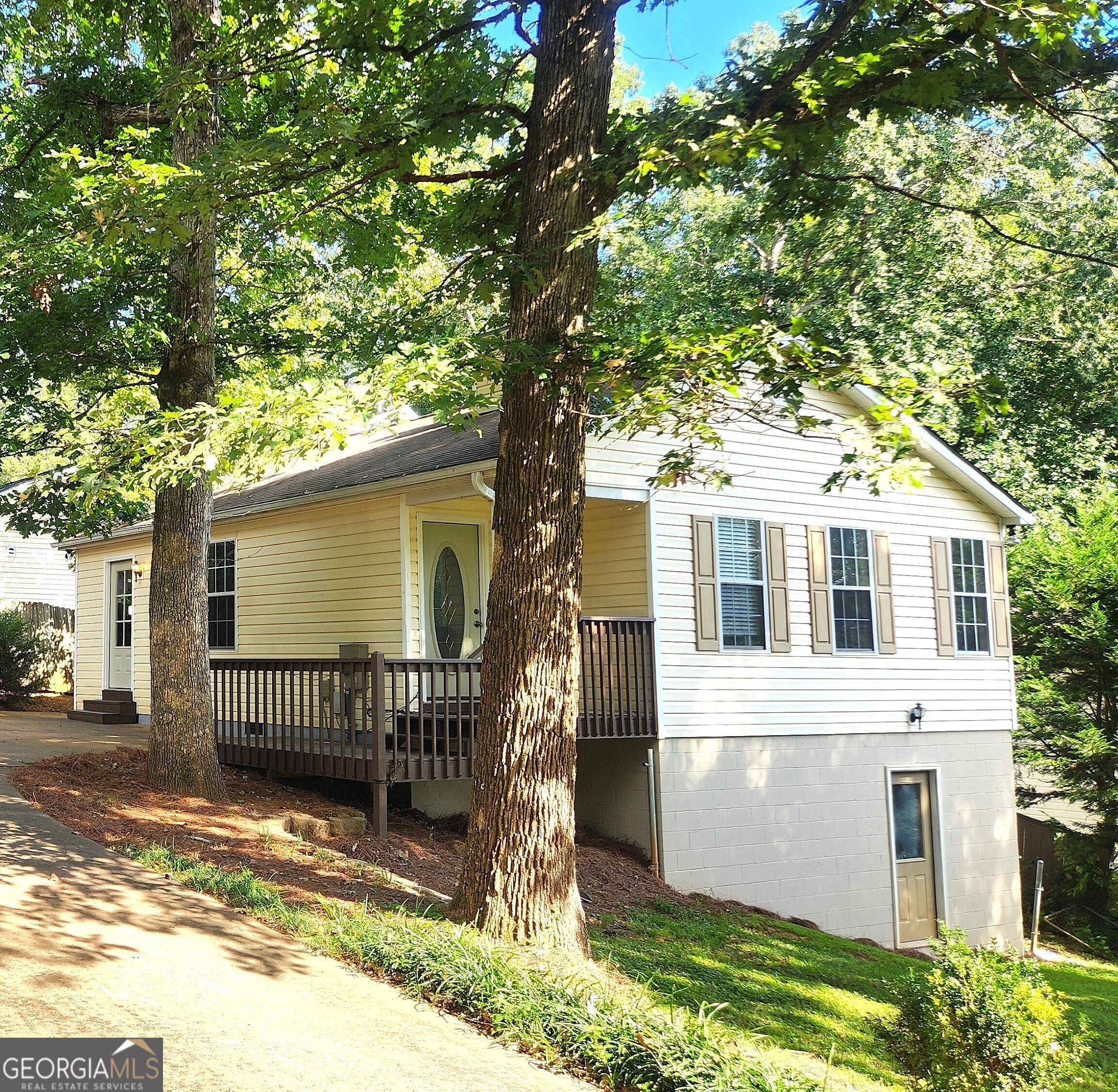 LOCATION LOCATION LOCATION! JUST MINUTES FROM LAKE LANIER w/ easy access to Boat ramps, Parks & Water Activities, GA 400, the OUTLETS, the VIBRANT CUMMING CITY CENTER & SO MUCH MORE!!! SO Many Options to make this your Weekend Getaway, AirBnb Rental, or Home!! Home is Located in the Tranquil Community of Shady Shores! This 2 Bedroom/ 2 Bath MOVE-In Ready Home features an Open-Concept Living Area! The Kitchen Offers BRAND NEW CounterTops, BackSplash, Sink, Faucets & Plumbing! ALL Kitchen Appliances are Included! Family Room Features a Cozy, Stone Fireplace!! There are also SO MANY Possibilities in the Partial Basement w/ Interior & Exterior Entrance! One Room is almost completely finished and the Crawl Space area was recently Encapsulated offering SO MUCH STORAGE!! Don't miss your OPPORTUNITY to own a Home in a Highly Desirable area!! It is PRICED TO SELL!! COME SEE TODAY!!!