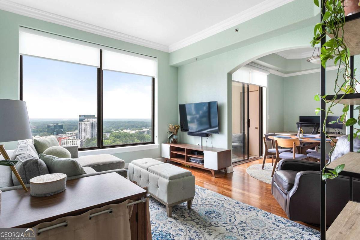 Enjoy Luxury living in one of Buckhead's Finest Highrise buildings with the Stunning Western Sunset Views from the 31st floor in the Paramount At Buckhead ! This Stunning 1 bed/1 bath condo is perfect for entertaining with views in every room ! The Spacious kitchen with stainless steel appliances, granite countertops, double sink, staingrade cabinets and a breakfast bar. The light, bright living room features hardwood floor, crown molding, built-in shelving and dramatic floor to ceiling windows with gorgeous views of the city, a large balcony and storage closet! This beautiful condo also features a large romantic master suite with carpets featuring a ceiling fan, crown molding and a spa bath with granite countertops, tile floor and shower/tub and huge walk-in california closet! This unit is unique as it comes with a GARAGE! . Step outside of Paramount, and you're in the heart of it all. Treat yourself to a nice massage at the Waldorf Astoria next door , easy access to MARTA to go in to town or airport, enjoy the delights of award-winning restaurant such as NOBU, ARIA, LITTLE ALLEY STEAKHOUSE, MAGGIANO'S, or indulge in retail therapy at Lenox and Phipps Malls. You are in close proximity to I-75, I-85, I-400 and within 15 mins to the airport. The Paramount has a unique short cut behind the building to escape all of the busy traffic on Peachtree and directly goes to Lenox to 400!!