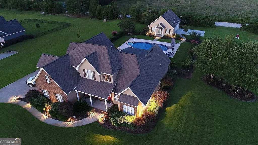 Stunning Family Retreat in Blackshear, GA - A Must-See! Property Address: 6112 Cottonwood Lane, Blackshear, GA 31516 Welcome to your dream home! Nestled just minutes from Blackshear or Waycross, this exquisite 5-bedroom, 3-bathroom residence offers an idyllic blend of comfort, luxury, and versatility-perfect for families, entertaining, or creating your private oasis. Spanning an impressive 3,501 heated square feet, every inch of this property is designed to impress. Features: Spacious Living Areas: As you step inside, you are greeted by an expansive open floor plan that seamlessly connects the living, dining, and kitchen areas. Sunlight pours in through large windows, creating a warm and inviting atmosphere for family gatherings or entertaining friends. Gourmet Kitchen: The heart of the home features a stylish kitchen equipped with modern appliances, ample counter space, and beautiful cabinetry. Cooking will be a delight here, whether you're preparing a casual family meal or hosting guests. Luxurious Bedrooms: This home boasts five generously sized bedrooms, providing ample space for family and guests. The master suite has am ensuite bath, tiled shower and huge master closet for ultimate relaxation and privacy. Mother-in-Law Suite/Pool House: Unique to this property is a mother-in-law suite / Pool House. The Current Owners use this 1,150 Heated and Cooled area for a pool house / Man Cave. It's truly a private guest retreat, it includes a cozy living area with a half bath and closet. The amazing thing is it's easy accessibility from the back entrance and it's own Heated and Cooled Garage / Shop / Lean-to looking over the Salt water pool. Outdoor Paradise: Step outside to discover your personal paradise! The salt water pool invites you to soak up the sun on warm days while the surrounding patio area is perfect for summer barbecues or evening stargazing. Versatile Workshop & Lean-To: For the hobbyist or DIY enthusiast, the property includes a spacious workshop ready for your projects. Additionally, the convenient boat/ATV lean-to offers shelter for your outdoor toys, making this home a perfect fit for adventure seekers. Location Benefits: Situated in a friendly neighborhood, this stunning property is just minutes away from local amenities, schools, parks, and shopping. Experience the charm of small-town living while having easy access to major highways for commuting to nearby cities. Whether you're looking for a peaceful retreat to call home or a vibrant space to entertain family and friends, 6112 Cottonwood Lane encompasses it all. Don't miss this rare opportunity-schedule your showing today and let your new chapter begin in this captivating Blackshear gem!
