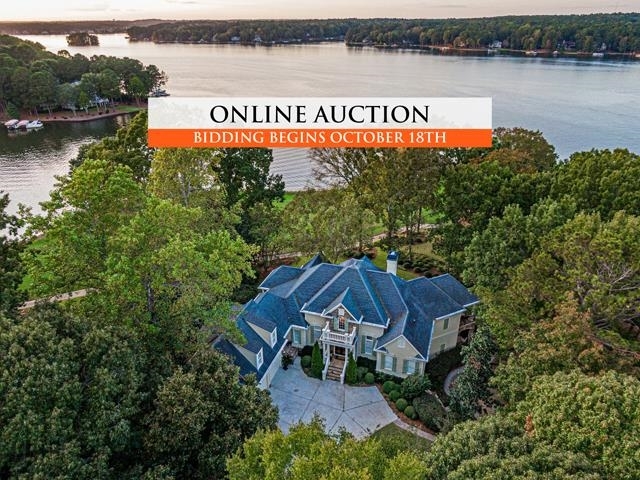 AUCTION – Seller offering property via online auction. Online bidding begins Monday, Oct. 18th with a starting bid of only $1.5M. Open house begins on Friday, Oct.15th. The lakefront and golf frontage custom home is located in Great Waters of Reynolds Lake Oconee. A stunning craftsman-style home that offers the very best of lake life, privacy and luxury living. Situated on a one-of-a-kind private peninsula, the 0.81± acre property and boasts 100± feet of private lake frontage, as well as Great Waters golf course frontage. This home is the one of the few homes in Reynolds Lake Oconee with a dock on the golf course! Enjoy long-range lake views from every room in this 7,068± sqft, 4 bedroom, 4 full / 2 half bathroom home, a 5th bedroom could be created out of the office. Extensive millwork and design showcased throughout, including a stacked stone, gas fireplace, 18 feet coffered ceilings, and hand-carved reliefs above the great room’s doorways. This custom home is ideal for hosting friends and extended family with ample living spaces, two gourmet kitchens, and with multiple balconies and patios. The owner’s suite is a retreat all its own, located on the main level with private balcony, custom dual walk-in closet, and lavish master bath. Private office with closet, tons of storage, and a double car garage. Club membership opportunity is available to the buyer. Agent is not engaging in auctioneering activities. Contact agent for full terms and conditions of the sale and to schedule appointment to preview the home.