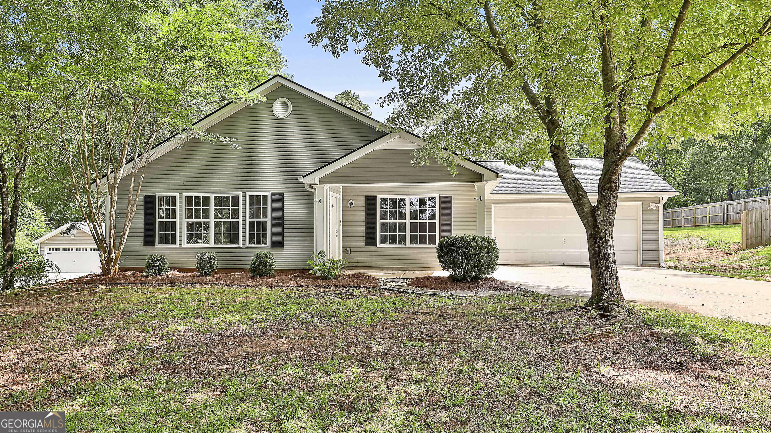 Welcome home to this charming and move-in ready 3 bedroom, 2 bath home located in highly sought-after Coweta County! This beautifully maintained residence features a bright and open floor plan that flows seamlessly from the living area into the kitchen and dining space-perfect for entertaining or everyday living. Enjoy the comfort of spacious bedrooms, updated finishes, and natural light throughout the home. The kitchen offers ample cabinet space, modern appliances, and a great layout for meal prep and hosting. Step outside to your own private oasis-an expansive fenced backyard with plenty of room for everything. The highlight of the outdoor space is the detached 30x40 workshop, ideal for hobbies or extra storage. Conveniently located near shopping, dining, and major highways, this home offers both comfort and convenience. Don't miss this incredible opportunity to own a low-maintenance home in one of Coweta County's most sought-after areas! Call The Charles Davis Team to get more information and schedule a showing!