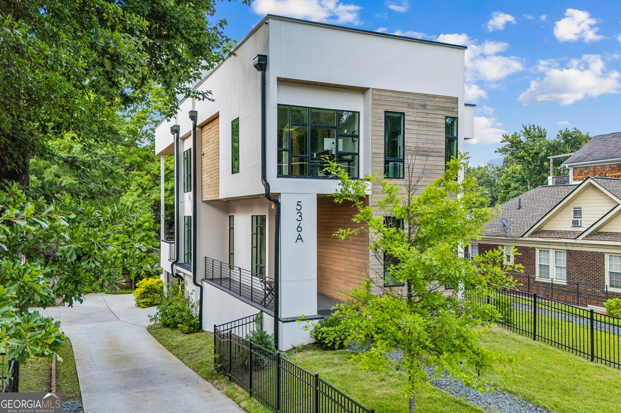 Contemporary Perfection in the Heart of Old Fourth Ward! Welcome to this One-Of-A-Kind, Architect-Designed Home by Hagan Architecture and Built by Domain Custom where Clean Lines, Elevated Finishes, and Thoughtful Design converge in one of Atlanta's Most Sought-After Neighborhoods. Perfectly positioned steps from Freedom Park Path and Freedom Barkway Dog Park, and just moments from the BeltLine, Ponce City Market, Krog Street Market, Inman Park Village, and Historic Fourth Ward Park, this home places you right in the middle of the best of Intown Living. You can truly leave the car behind and be steps away from coffee, dining, parks, and shopping including local favorite A Mano, a charming Italian restaurant just a few blocks away. This Four-Story Home is packed with Standout Details, beginning with the Oversized Front Porch that opens into a Bright, Open Layout. Inside, discover Sky-High Ceilings, Gorgeous Hardwoods, and Light-Filled Living Spaces that flow seamlessly throughout. The Custom Chef's Kitchen is a total showstopper, with a Massive Marble Island, Top-Of-The-Line Appliances, Custom Wood Cabinets, Open Shelving, and a full wall of Zellige Tile Backsplash that adds just the right amount of texture and shine. The Dining Area, Wrapped in Windows with Balcony Access, is the perfect place to share meals, make memories, and enjoy Al Fresco Dining. The adjacent Great Room impresses with its Atrium-Style Ceiling, sleek modern accents, and direct access to the Large Rear Porch, creating an ideal setup for Indoor-Outdoor Living. Also on the Main Level: a Private Guest Bedroom with Full Bath perfect for overnight visitors or a Work-From-Home setup. Upstairs, the Spacious Primary Suite feels like a High-End Hotel Escape, featuring a Wall of Windows, Large Walk-In Closet, and a Spa-Inspired Bathroom with Stone Double Vanity, Glass-Enclosed Shower, and Designer Finishes. Two additional Generously-Sized Bedrooms each offer access to Full Bathrooms, and you'll find Smart Storage Solutions throughout. Downstairs, the Terrace Level includes a 2-Car Garage, a Spacious Mudroom with Built-In Cubbies, and Additional Storage/Mechanical Rooms. There's even a Tesla Electric Charger installed in the garage for modern convenience. The home is Elevator Ready, with a 4-Stop Shaft currently used as closet space on each level, providing built-in flexibility for the future. And don't miss the Huge Crawl Space on the south side of the house offering Bonus Storage Space that's rarely found in homes like this. To top it all off, the Private Rooftop Oasis is an entertainer's dream complete with Skyline Views, Multiple Lounge Areas, Turf Lawn, and plenty of space for Outdoor Dining, Grilling, or even a future Hot Tub or Expansion. This home is a Rare Opportunity to own a Truly Custom, Design-Forward Property in one of Atlanta's most Vibrant, Walkable Neighborhoods. Don't miss your chance to call this Contemporary Stunner home it's ready for you to move right in and enjoy the very best of City Living.