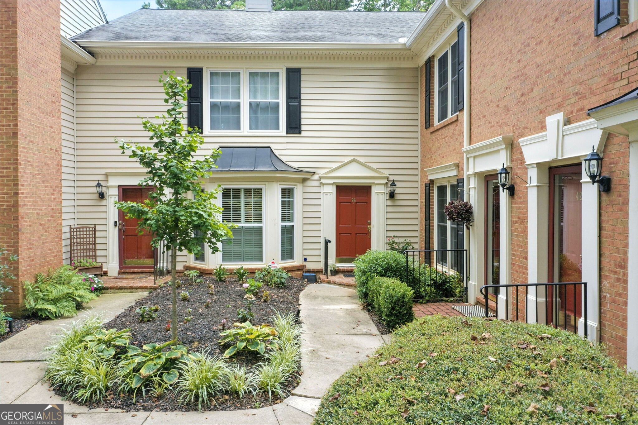 LOCATION MEETS LIFESTYLE-Welcome to Mount Vernon Plantation a beautifully maintained, gated community in the heart of Sandy Springs/Dunwoody. This rare, move-in ready 2 BR/2.5 BA end-unit features a hard to find true OPEN FLOOR PLAN! Upon entering you are greeted by a large open concept living room with fireplace and flexible dining room/sitting area which flows into the bright, sunlit kitchen with solarium windows. The spacious eat-in kitchen has stainless steel appliances, granite countertops, breakfast bar, and pantry. Just off the kitchen is the large back deck with serene, private views, perfect for relaxing or entertaining. On the upper level, you will find the primary suite and guest bedroom, each with private bathrooms and lots of closet space. The upper laundry room is a nice added bonus! Updates in 2025: NEW HVAC, NEW kitchen glass windows, and NEW carpet (limited areas). Community amenities include: Club house, pool, tennis court, garden, private walking trails, playground, duck pond and dog park! Close to GA400, I-285, Perimeter Mall, Politan Row Food Hall, Costco, Marta, parks, etc.. Look no further for a unique blend of quiet, secure living and easy access to everything that you may need! SMART MOVE!!