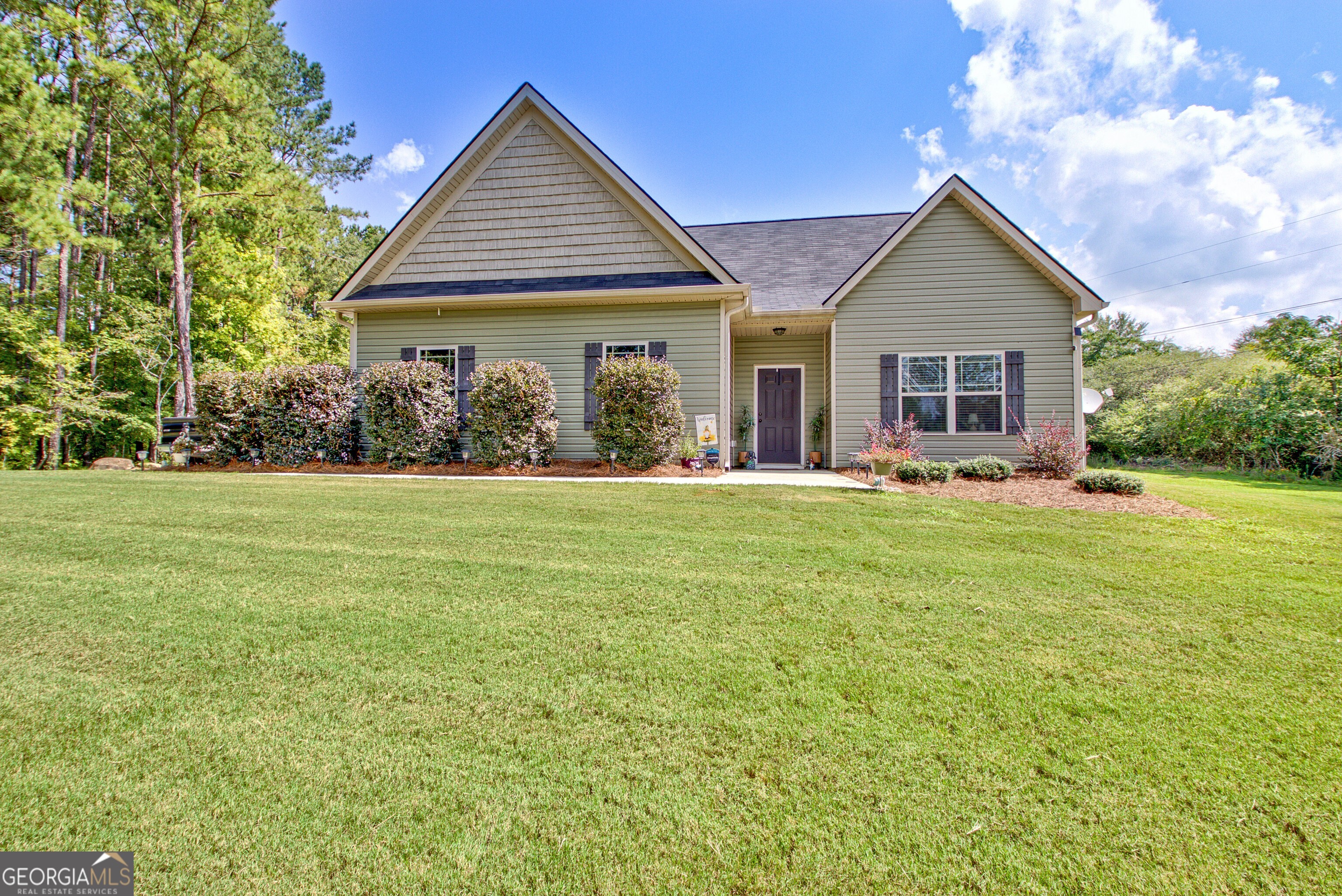 Welcome to this beautiful 3-bedroom, 2-bath Craftsman-style ranch with bonus room, offering 1,668 sq ft of comfortable living space. Built in 2020, this home combines modern design with timeless charm, featuring a desirable side-entry garage and an open, floor plan filled with natural light from an abundance of windows. The kitchen is a true highlight, complete with an island housing the sink and dishwasher, granite countertops, ample cabinetry, and stainless steel appliances including a range and built-in microwave. Craftsman-style trim accents on the doors and windows add character and warmth throughout. A spacious bonus room provides flexibility for a home office, playroom, or guest retreat. Outside, you'll enjoy more than 5 acres of land in a highly desirable area offering both privacy and endless possibilities for outdoor living. This property delivers the best of both worlds: a move-in ready modern home with the space and freedom of acreage.