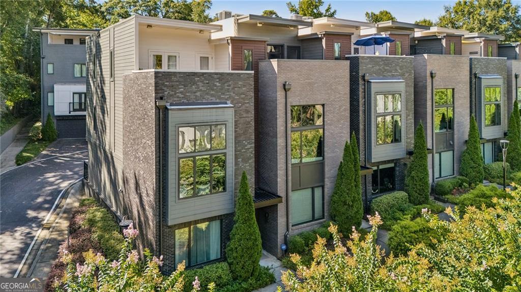 In the very heart of Oakhurst Village, this stylish 4-bedroom townhome brings together space, convenience, and community. This multi-level living truly fits modern day life. Whether you need a separate home office, nearby nursery, distanced teen suite, or just giving everyone in the household room to spread out, this home provides a flexible layout to adapt to your family's changing needs. 728 Oakview gets 5 stars for Location, Ease, and Function. Location. What really sets this home apart is the lifestyle at your doorstep. Everything you need is within a block! Stroll to get your morning coffee, pop out between calls to get a sandwich at Oakhurst Market, grab a beer at Sceptre Brewing, and choose between multiple restaurants for dinner. Necessities are here from the pediatrician and eye doctor to gym and convenience store. Enjoy the small town feel where kids walk to award winning schools on weekdays and weekends feature festivals and events without ever leaving the neighborhood. Hop on your bike and you're downtown Decatur in 5 minutes! Ease. Step inside 728 Oakview and see how life is as easy at home as it is to grab a bite when you don't want to cook. With exterior upkeep, roof, and common spaces all maintained by the HOA, you can spend less time worrying about chores and more time enjoying that Oakhurst lifestyle in this fee simple townhome. Function. The main living and dining area make a dramatic first impression with soaring two-story ceilings and a wall of windows that bathe the space in natural light. Just a few steps up, the open kitchen feels both connected and distinct. Close enough to stay part of the action yet thoughtfully set apart to create an easy rhythm between cooking, dining, and relaxing. European-inspired finishes bring a modern edge to the heart of the home. A rare attached two car garage make bringing in groceries and storing bikes and toys a breeze. The four bedrooms boast two en-suites and a jack + jill style top level. One of the home's most distinctive features is the upper-level retreat with French doors to the private rooftop balcony creating a unique escape among the trees. Currently used as the primary sanctuary, it can also function as an indoor-outdoor entertainment space. Come see for yourself how 728 Oakview is the perfect combination of location, ease, and function with a healthy dose of elegance!