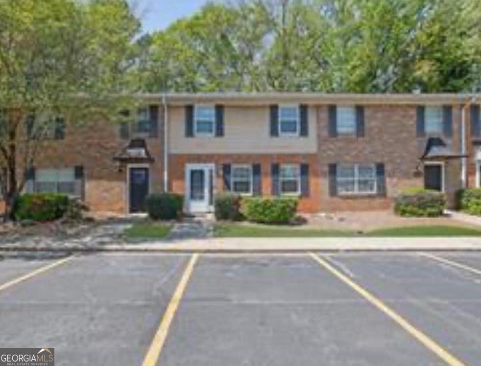 Renovated and move-in ready! This is the ONLY townhouse available in Northdale Condos, offering 3 bedrooms and 2.5 bathrooms across two levels. Enjoy a brand-new kitchen, renovated bathrooms, new lighting, hardwood floors, and many more updates for you and your family. The spacious layout features an electric fireplace, modern appliances (dishwasher, dryer, microwave, gas oven/range, and refrigerator), plus 2 assigned parking spaces. The community HOA covers exterior maintenance, common areas, and private roads. Conveniently located near Gwinnett County schools: Lawrenceville Elementary, Moore Middle, and Central Gwinnett High. Homes like this move quickly-schedule your tour today.