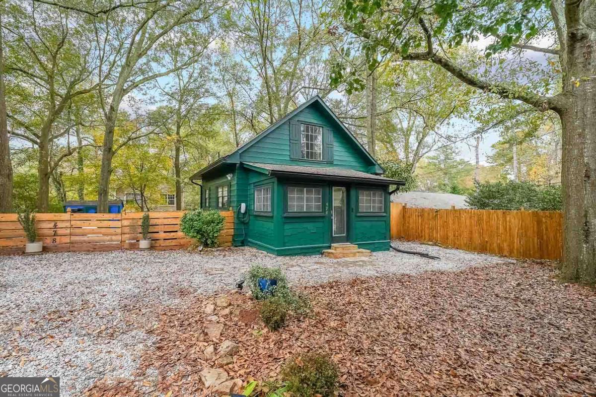 Welcome to this unique cottage-style property in the Pine Lake Community. This stunning 2-bed 1-bath cottage is a rare gem that perfectly blends rustic charm with modern luxury! Fully renovated, this unique residence boasts stainless steel appliances, soaring ceilings, and an open-concept design that invites warmth and natural light. The character of the home balances functionality and charm, while contemporary upgrades offer effortless comfort and style. The beautifully designed kitchen features pristine quartz countertops and stainless steel appliances that make cooking and entertaining a breeze. Enjoy the added charm of the second bedroom loft with a looking glass that overlooks the living room, perfect for a cozy retreat or extra living space, and take in the breathtaking views of Pine Lake just a short walk from home. Plus, enjoy exclusive access to Pine Lake Beach, where you can play sand volleyball and take part in community-hosted music, art, and activities for residents. Situated on a beautiful private lot, this property also features a fire pit area, picnic table, and a private backyard patio, perfect for relaxing or entertaining. Enjoy plenty of parking with an electric car charger. Nestled in a serene setting, this one-of-a-kind home is a must-see. This meticulously crafted home is waiting to be your private sanctuary. Close to everything in Decatur, Atlanta, and Stone Mountain!