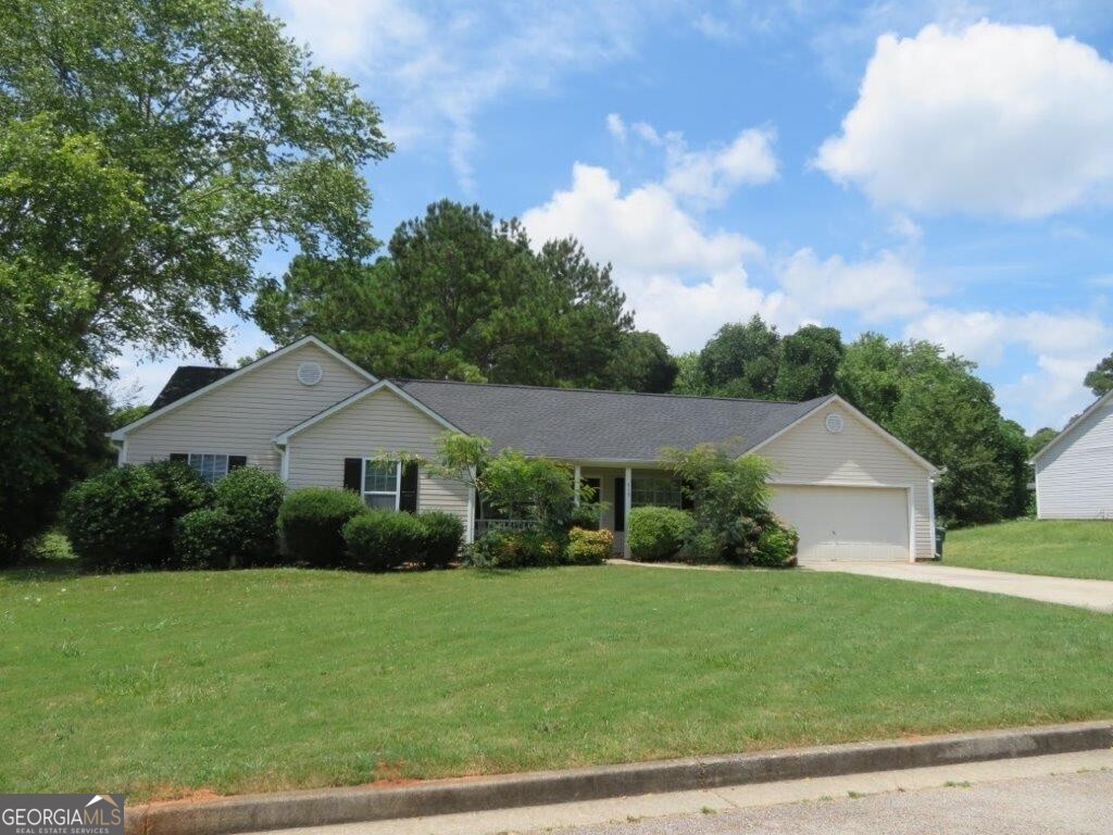 Beautiful ranch home in Emerald Springs! Large, 0.4 acre lot! Covered front porch! Spacious living room with stone fireplace and vaulted ceiling! Separate dining/breakfast area off kitchen! Kitchen features white cabinets, stone counters, and stainless steel appliances! Large primary bedroom with walk-in closet and private bathroom! Two spacious secondary bedrooms share another full bathroom! Rear deck overlooks large backyard! A must see! Submit your offer today!