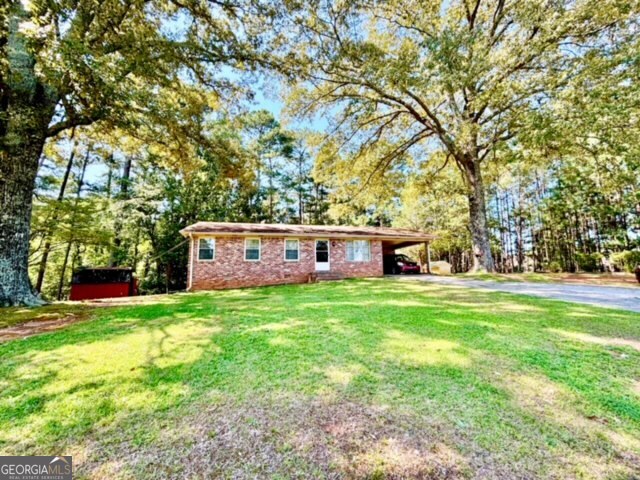 Lovingly maintained and cute as a button! Wonderful all brick ranch with 2 bed/1 bath on over 1/2 acre lot, outbuilding with electricity, shelving and lights, beautiful mature oaks trees, other than needing some cosmetic updates, this sweet home is in great condition and move-in ready. New HVAC/furnace installed 2023! Fire station 1 mile away, convenient to popular eateries and grocery stores, 14 miles to ATL airport **Tax record is inaccurate noting 3 bed/2 bath, listing agent spoke with Mr. Davenport @Fulton Co, he stated would be corrected and updated in system, but may not update to q-public until 2026. Showings can begin on Saturday 9/13.
