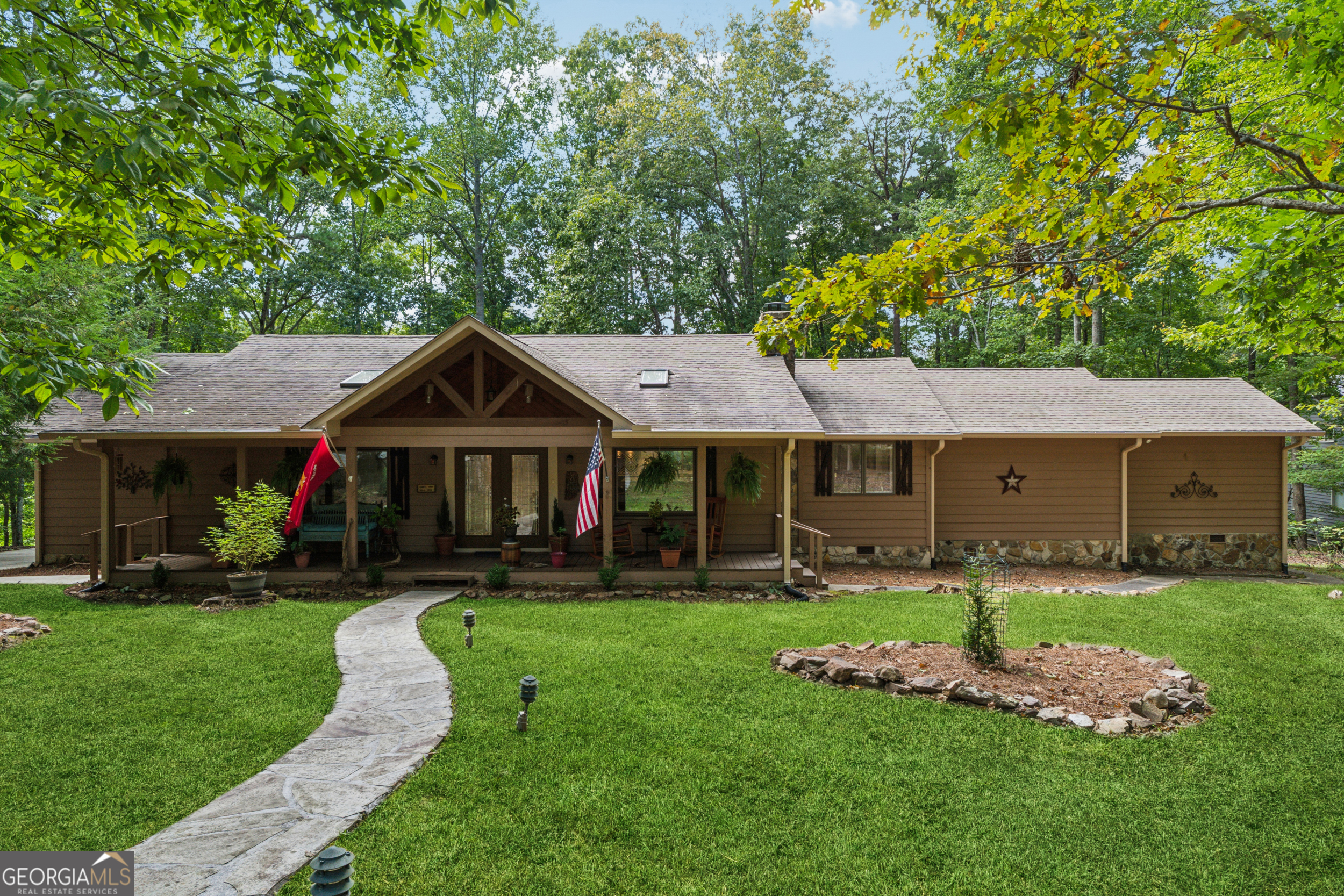 Discover one of the most sought-after locations in the gated Bent Tree community, where convenience meets tranquility. Perfectly positioned with easy access to both the front and back gates, this fully renovated 3-bedroom, 3-bath ranch offers 2,209 sq ft of thoughtfully designed living space on a sprawling 1.44-acre lot along the shores of the 110-acre private, fully stocked Tamarack Lake. A level front yard and newly poured concrete driveway with additional stone parking pad welcome you to the charming rocking-chair front porch. Inside, hardwood floors flow throughout the main living areas, accented by a ship-lap wall and original masonry fireplace with new gas logs and remote starter. The open-concept living, dining, and kitchen area overlooks the expansive backyard, complete with stepping stones to a serene lakefront viewing spot. The chef's kitchen is a showpiece, featuring an oversized quartz island with seating and storage, stainless steel appliances including an induction cooktop with convenient pot filler, double convection wall oven, in-built microwave drawer, and wine cooler. A double undermount sink frames peaceful lake views. Retreat to the renovated guest suite with a sitting room, tiled bath, and direct access to the vaulted screened porch-ideal for enjoying vibrant seasonal views. The owner's suite boasts built-in closets, a freshly updated bathroom with stepless tile shower, and enhanced year-round comfort with additional HVAC vents hooked up to a brand new hybrid dual-fuel heating and air conditioning system. Additional updates include new windows throughout (2025), fresh paint inside and out, 10" depth spray foam insulation in attic, gutter guards, a 2024 whole-home Generac generator, April Air dehumidifier, and freeze-proof spigots. Just minutes away, enjoy Bent Tree's unmatched amenities: a golf course with the 19th Hole Tavern, Beach Pavilion where you can enjoy beach volleyball, bocce and basketball. Premier pickleball and tennis facilities, two pools, clubhouse, hiking trails, walk-in access to Eagle's Rest park, a dog park, and the newly renovated library and Bent Tree Animal Shelter - a safe haven for lost cats and dogs. Added benefit of 24/7 EMT security for emergency situations. With electric-motor boating allowed on Tamarack Lake, along with boat storage and boat launch, your backyard is a year-round playground. This is more than a home-it's a lakefront lifestyle in Bent Tree's premier setting.