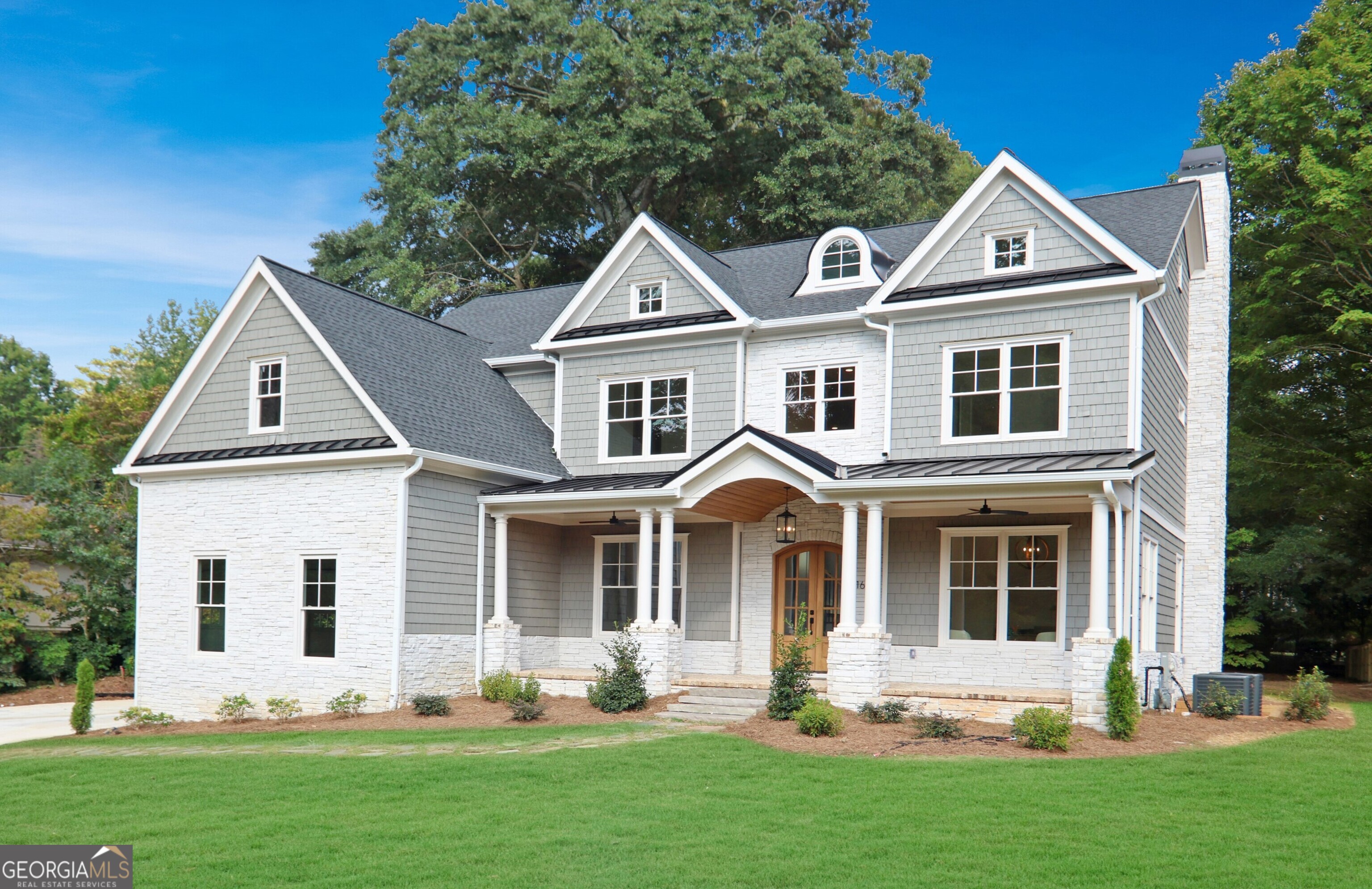 Perched gracefully on a .7-acre lot along the desirable stretch of Oak Grove Road, this stunning new build offers the perfect blend of timeless charm and modern luxury. Just a short stroll to Oak Grove's beloved shops and restaurants, the home's stately curb appeal is enhanced by its columned front porch, cedar shingles, and tongue-and-groove ceiling details. Step inside to a dramatic two-story foyer, where intricate hardwood and tile inlays showcase craftsmanship rarely found in today's new construction. Flanking the entry are a handsome study and a formal dining room. The open yet inviting floorplan balances everyday living with exceptional entertaining spaces. The chef's kitchen features Thermador stainless appliances, including a 48" gas range and 42" refrigerator, along with an expansive island, quartz countertops, custom cabinetry, and a walk-in pantry with a charming reclaimed door from the early 1900s. A mudroom with built-in storage connects to the three-car garage for everyday convenience. A main-level bedroom with full bath provides flexible space for guests or multi-generational living. Upstairs, the primary suite is a true retreat with an awe-inspiring closet and a spa-like bath. An additional family room, two bedrooms with a Jack-and-Jill bath, plus a private ensuite bedroom complete the upper level. The sprawling backyard is ready to accommodate a pool, play space, or pets, while the encapsulated crawl space provides excellent storage. All of this in an unbeatable location just minutes to Toco Hills, Emory/CDC, the new CHOA campus, and all that Atlanta has to offer.