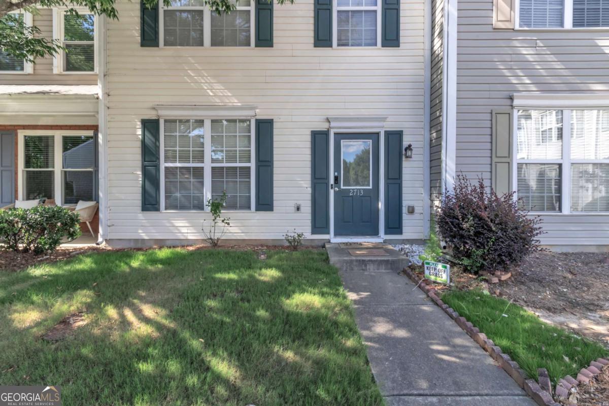Don't miss this incredible opportunity to own a beautifully maintained townhome in the highly sought-after community of Windward Pointe! Located at 2713 Ashleigh Lane in the heart of Alpharetta, this charming two-story residence offers the perfect blend of comfort, convenience, and low-maintenance living. Step inside to discover an open-concept floor plan featuring a spacious living room with abundant natural light, perfect for relaxing or entertaining guests. The bright kitchen boasts modern appliances, ample cabinet space, and a breakfast bar that flows seamlessly into the dining area. Upstairs, you'll find two generously sized bedrooms, including a luxurious owner's suite complete with vaulted ceilings, a walk-in closet, and a private en-suite bath. A second full bath and laundry room provide added functionality and ease. Enjoy morning coffee or evening breezes on your private back patio, with a quiet wooded backdrop offering extra privacy. This well-kept community features beautifully landscaped grounds and is conveniently located just minutes from Avalon, downtown Alpharetta, top-rated schools, parks, and GA-400. Whether you're a first-time buyer, downsizing, or looking for a great investment, this move-in ready home is a must-see!