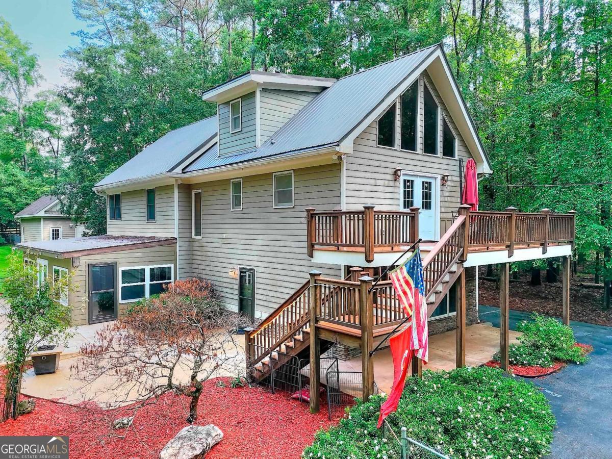 Amazing Home! This is a one-a-kind home full of charm and space galore. Marketed as 3 bedrooms but there could easily be four with an extra room to boot! Located in a quiet community with Lake Oconee access, this home features a saltwater pool and hot tub. The detached garage is heated and cooled by a mini split and has a large area above that could be finished for even more living space. Homeowner spared no expense in updates: recent renovations include composite decking, metal roof, all new baths, and replaced concrete around the pool. If you are looking for charm, lots of space with plenty of privacy, you've just found home!