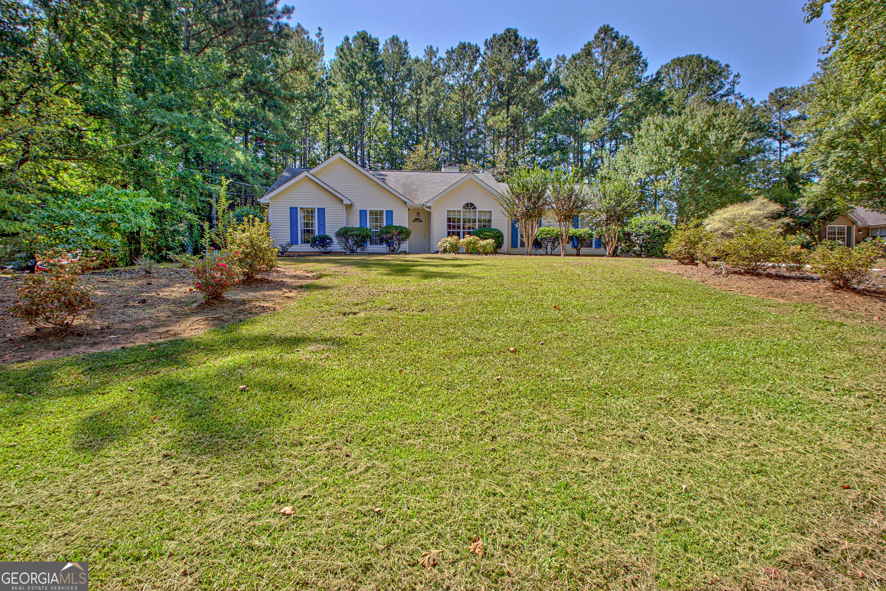 Come and call it HOME! Well maintained, 3 bedroom & 2 full baths, all on main level. Great room and bedrooms have vaulted ceilings so open and bright feeling. Great room and kitchen are open to each other with warm inviting fireplace in great room. LVP throughout the home. Kitchen has Samsung SS 5 burner stove/oven & SS microwave. Two car side entry garage with additional gravel parking area. No HOA. Back patio has an electric sun shade that can be used when desired. Private fenced backyard on over 3/4 of an acre. Shed that is approximately 8x10 remains with home. Convenient location to Newnan, Senoia and Peachtree City.