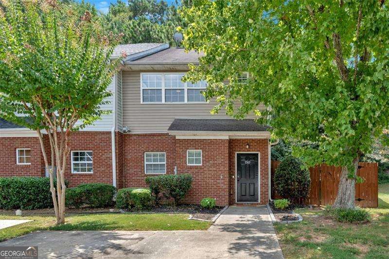 Welcome to your dream home in Smyrna, Georgia! This beautifully renovated 2-bedroom, 2.5-bathroom townhouse boasts modern elegance and convenience, making it perfect for both entertaining and cozy living. Step inside to discover a bright, open layout adorned with brand-new LVP flooring and custom kitchen features. The chef's kitchen showcases stunning quartz countertops, custom-made cabinets, and new Samsung appliances, including a built-in beverage fridge. A custom pantry closet offers ample storage, while a cozy fireplace serves as the centerpiece of the living area, ideal for chilly winter nights. On the main level, a convenient half bath is perfect for guests, while the second floor features an ideal roommate floor plan with two spacious bedrooms, each with its own beautifully renovated ensuite bathroom. All bathrooms have been updated down to the studs, featuring custom-built cabinets and elegant tile work. Enjoy outdoor living in your fully fenced yard, complete with a firepit for gathering with friends and family. An outdoor shed provides additional storage, ensuring that your space remains clutter-free. Take movie nights to the next level with an outdoor projector-perfect for warm summer evenings under the stars! Located just steps away from Smyrna staples like Smyrna Market Village, Mezza Luna, Rev Coffee, Ruby's Pizza, this home offers the perfect blend of tranquility and urban convenience. Plus, with Truist Park just a 10-minute drive away, you'll never miss a game! This charming home is a must-see. Don't miss your chance to make it yours!
