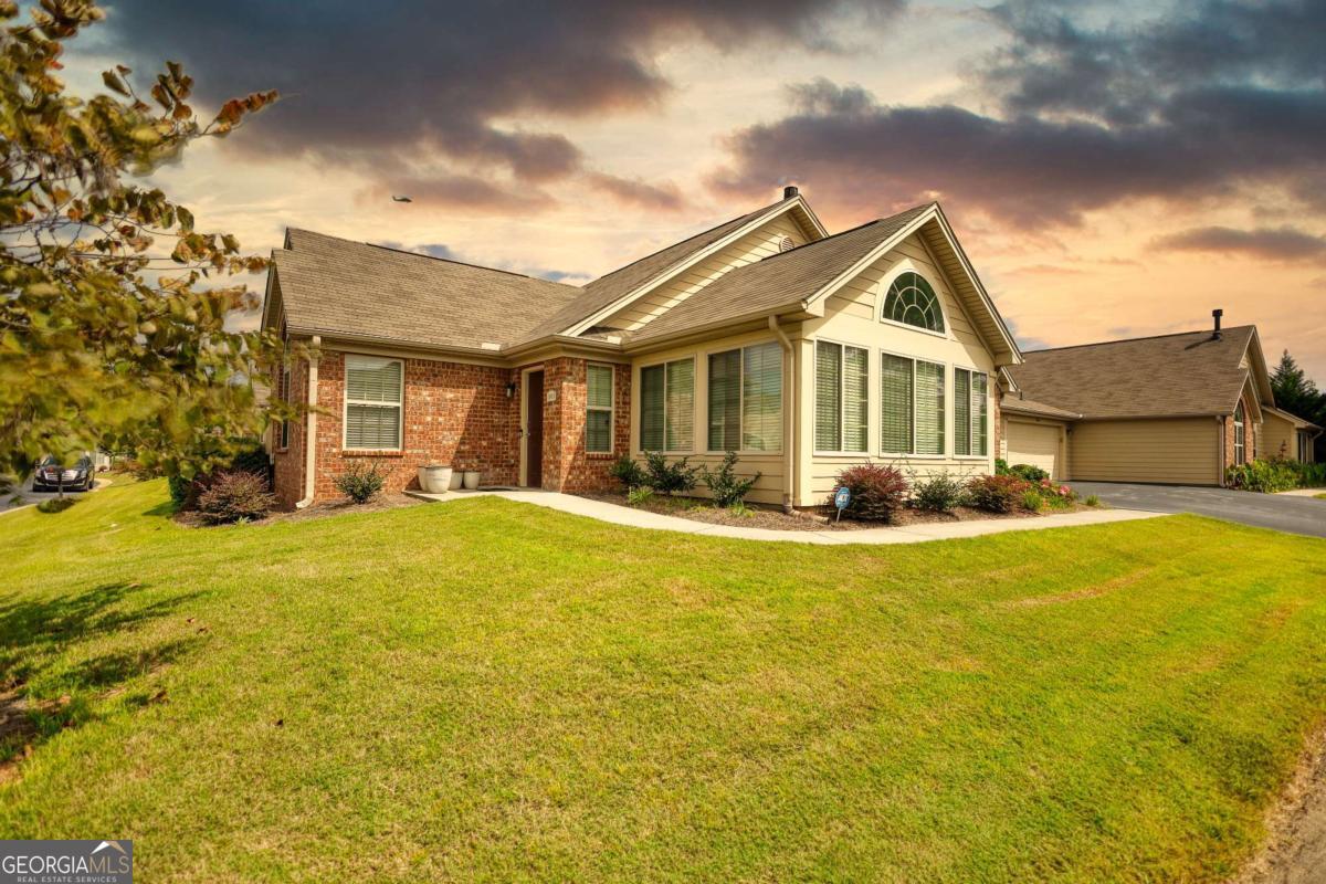 Don't miss your chance to own this impeccably maintained home in the highly desirable 55+ Silver Summit Community in Conyers, GA! Located in the newer Phase II section, this spacious and thoughtfully designed unit offers modern comfort, accessibility, and low-maintenance living! The open-concept floor plan and open, airy living spaces is ideal for both entertaining and everyday life! Seamlessly connecting the expansive living and dining areas allows for plenty of natural light to flow throughout! A bright and inviting sunroom provides the perfect spot for morning coffee or evening relaxation. The well-appointed kitchen features two pantry closets and a large walk-in pantry/laundry, offering exceptional storage space. The home also includes a handicap-accessible layout designed for ease and comfort. Additional peace of mind comes with a roof that is less than 10 years old. Silver Summit offers an array of resort-style amenities, including a swimming pool, fitness center, clubhouse with an entertainment space, and a fully equipped community kitchen-ideal for social events and neighborhood gatherings. Tucked within a quiet and friendly neighborhood, this home presents the perfect blend of tranquility and active living. Opportunities like this are rare-schedule your private showing today before it's gone!