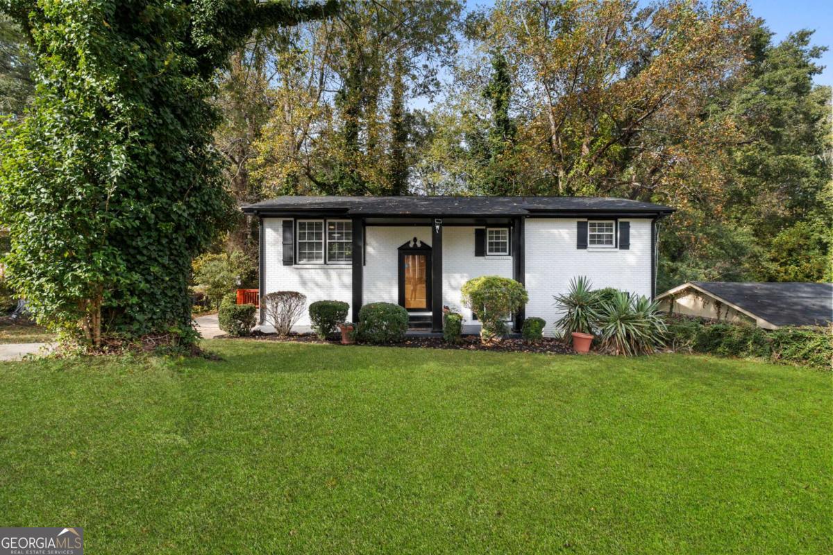 Welcome Home to Refined Modern Living!  Out with the old and in with the extraordinary. This meticulously remodeled home has the feel of a new build and the comfort and character of a thoughtfully designed home. Every finish reflects quality craftsmanship, attention to detail, and a designer's touch you can trust.  Step inside to an open-concept floor plan that effortlessly blends elegance and functionality, featuring 4 spacious bedrooms and 2 full baths. The heart of the home is the kitchen, showcasing premium quartz countertops, a classic white subway tile backsplash, 42" soft-close cabinets, stainless steel appliances, and a farmhouse sink, with an opening view to the family and dining area all designed to inspire and effortlessly entertain.  The interior exudes style with a new roof, new shutters, new windows throughout, luxury vinyl plank flooring throughout, custom designer lighting fixtures, iron stair spindles, stained hardwood stairs, and a board-and-batten accent wall that adds a touch of modern artistry. Every element from the new interior and exterior doors to the French patio doors leading to outdoor living spaces. All intentionally selected finishes to ensure timeless appeal and quality that lasts.  The finished basement expands your lifestyle possibilities, offering a family room, bedroom, full bath, laundry area inside a finished flex/storage room which can also be perfect for a home gym, office, or endless possibilities.  Step outside onto the beautifully stained deck, an inviting extension of your living space ideal for gatherings, morning coffee, or evening relaxation looking out to serene nature.  Perfectly situated in the highly sought-after Cascade area, you're moments from local dining, shopping, Cascade Heights attractions, and just minutes from Downtown Atlanta, Midtown, and Hartsfield-Jackson International Airport.