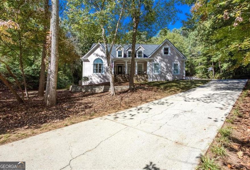 Expect value and security in your dream home. Welcome to this inviting cottage-style home with interiors that unfold into surprisingly generous spaces, blending cozy charm with unexpected room to live, work, and entertain. New roof, siding bonded and secured by a professional company that transfers to you, and a long list of cosmetic updates that make this house feel like your dream home. First, you are going to love the privacy and how the house sits on the mini cul-de-sac, set back from the street towards the rear of this enclave of 24 homes, nowhere within a major road. As you pull in, you'll have plenty of room for parking between 2 garages on the main level, boat door for your boat, project car, or riding equipment on the terrace level, and additional parking pads outside the delivery door off the kitchen. For entertaining you have a three seasons room off the massive kitchen which includes a keeping area perfect for reading and early morning quiet time, adorned by a shiplap fireplace and rustic mantle for setting the easy going tone. During the warmer months, you and guests will make amazing memories in the fenced, level, grassy backyard, with immediate access to your large pool with diving board. There's room for chairs and tables, and the pool doesn't feel crowded. Inside the house, during your day to day living, you'll enjoy your gracious master suite on main with vaulted ceiling, dressing room, large bath area, linen closet, and secondary walk-in closet. Formal living room can be used as your office or additional entertaining space, and the grandiose family room with a stack stone fire place suggests a cathedral feeling with the floor set lower that the adjoining rooms. The dining room easily seats 12, if not more, and laundry is located near the garage off the kitchen, with its own sink, because you'll probably get your own garden going in the spring, just outside at the end of the driveway. Upstairs features more rooms that you can count. Don't be surprised if you have to walk through it twice to get all the rooms straight in your head, as they are very spacious and have incredible amounts of storage, unlike anything you may have seen before. One bedroom has its own private bath and the other has a jack and jill bath. The bedroom at the end of the hallway on the Eastern end of the house has a bonus playroom over the garage, perfect for privacy or play, such that it has the effect of being its own wing. Once you make your way to your entertainer's terrace level, you'll have the option for a billiard room or secondary living area. Depending on your needs, this versatile space offers the opportunity for renting out, creating a room for video blog or content creation, space for a secondary office or craft and activity room, and it's own refrigerator, stove with exterior vented hood, and bar sink for a mini kitchen, additional storage rooms, and full bathroom. Finally, just relaxing outside will be pleasant since the private backyard backs up to an estate lot, and just over .7 acre lot makes sure no one is right on top of you. Top rated Cobb Schools and highly rated private and charter schools nearby provide additional value. Finally, don't forget to check out nearby Oregon Park, Kennesaw Mtn Park, and Lost Mtn Park for more fun and activities with your guests. Convenient to area shopping and dining. Seller offering $8500 in concessions.