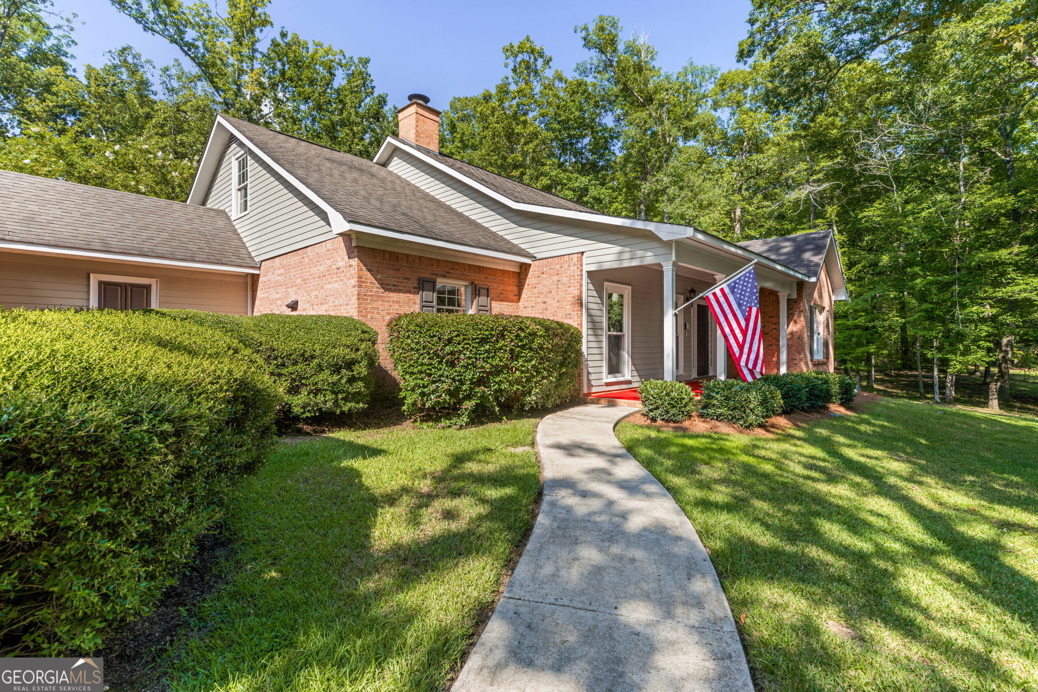 Set on a secluded clearing in the woods, this beautiful ranch home is incredibly serene. Located at the back of a community road on 3.38 acres, this home features a primary bedroom on the main floor, upstairs secondary rooms, a bonus room and storage over the garage, a full apartment or in-law suite, plus a separate large workshop. This house has room for everyone in the family to relax and thrive with easy to maintain, polished floors, a sunroom, screened in porch, outdoor kitchen, plus a relaxing waterfall. The kids will enjoy playing on the playground and exploring the forest. The hobby-ist can finish that project in the workshop with room for a car. In-laws can enjoy the peace of their own bedroom/kitchen/living room plus porch while also being connected to exciting family days. Schedule your appointment and drive to the top of the hill to see how your family can flourish at this residence today!