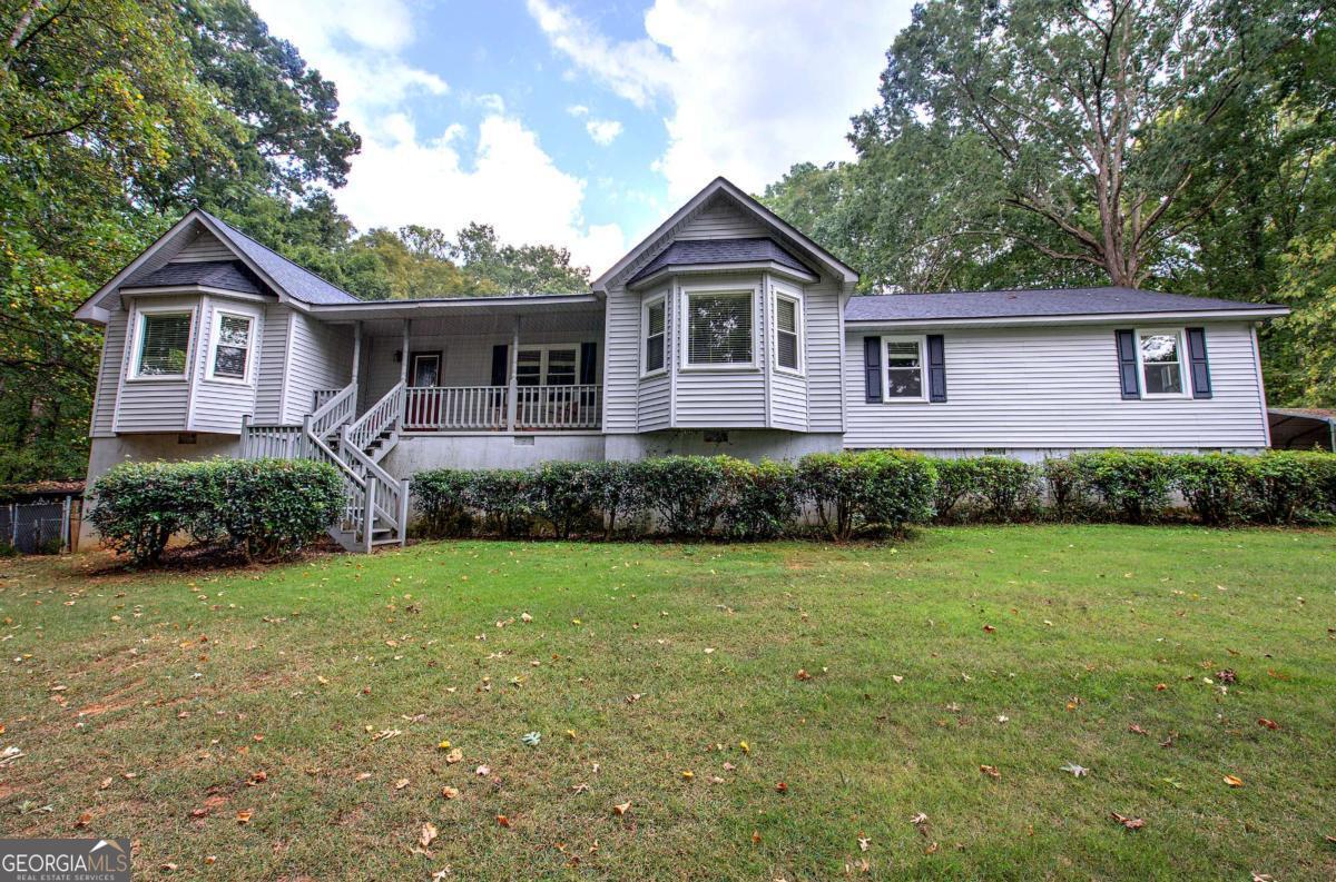 Welcome to this stunning one-level ranch-style home situated on five private acres with a long, winding driveway framed by mature hardwood trees. This spacious residence features three bedrooms and three and a half bathrooms, offering both comfort and functionality. Designed for relaxation and entertaining, the home boasts an in-ground swimming pool with a charming pool house and a second kitchen, providing convenient access for outdoor gatherings and poolside dining. In addition to the main home, the property includes a three-bedroom, two-bath mobile home with a newer roof and HVAC system, perfect for extended family, guests, or rental income. With its serene setting and abundant outdoor space, this property offers a private retreat while remaining close to everything you need. Located just minutes from interstates, highways, shopping, Hamilton Crossing Park, schools, restaurants, hospitals, and country clubs, this property combines the best of country living with modern convenience.