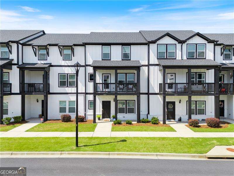 PRIME LOCATION, IMMACULATE TOWNHOME, MOVE-IN-READY!! ** Welcome to a VIBRANT lifestyle in the heart of Woodstock! This beautifully maintained newer townhome offers the perfect blend of CONVENIENCE, comfort, and community. Nestled in a prime area, you'll be just steps from The Outlet Shoppes of Atlanta, multiple parks for hiking, mountain biking, fishing, and kayaking, plus a scenic trail system that leads you straight into downtown Woodstock-home to amazing SHOPPING, DINING, and CONCERTS. Commuting is a breeze with quick access to I-575 and the Peach Pass lane for an easy drive into Atlanta. Inside, you'll find an open floor plan with a spacious kitchen featuring warm wood cabinetry, a massive island, stainless steel appliances, and granite countertops. The oversized breakfast/dining area is perfect for family gatherings, while the cozy deck offers a peaceful view of wooded privacy and a small mountain range. This home boasts four generously sized bedrooms, including a luxurious owner's suite with a walk-in shower, double vanities, and a large walk-in closet. A main-level bedroom with a full bath makes an ideal teen or in-law suite. Community amenities include a sparkling pool and walking trails, adding to the outdoor lifestyle. TO TOP IT ALL OFF, the seller is including all appliances-kitchen refrigerator, washer, dryer, and even a garage refrigerator (perfect for extra Costco finds right next door!). Whether you're looking for a move-in ready home or a turnkey investment property, this immaculate townhome checks all the boxes. Don't miss your chance to own in one of Woodstock's most sought-after locations-schedule your showing today!