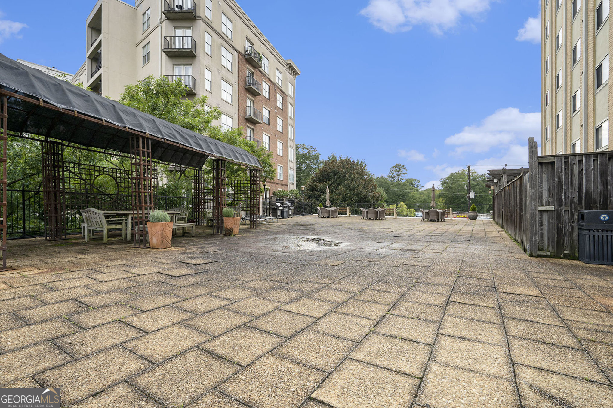Location, Location, Location! Welcome to Your New Buckhead Condo - with No Long-Term Rental Restrictions! This move in ready spacious 6th-floor end unit offers one of the largest one-bedroom floor plans in the building, complete with sweeping views of Buckhead. Step inside to find a fully remodeled kitchen and bathroom that seamlessly blend style and functionality. The open-concept kitchen flows into the living room and features: Granite countertops, Stainless steel appliances, Gas cooktop and oven, Built-in microwave, Large under-mount stainless steel sink, Beautiful stained soft-close cabinetry, Breakfast bar for casual dining. A matching wine bar-complete with granite countertops and custom stained cabinets-adds a touch of luxury and is perfect for entertaining. The spacious bedroom includes a walk-in closet with added shelving for optimal storage. And here's the best part: All utilities are included in the monthly HOA fee-that's water, electricity, gas, sewer, trash, internet, cable, grounds maintenance, building maintenance, pool maintenance and pest control all in one payment! Building amenities include: Salt water 8ft. pool, Expansive terrace and outdoor grill area, Fitness center, Laundry facility, Secure entry, Gated parking garage. Whether you're looking for your next home or a lucrative investment property, this condo delivers. Perfectly located next to Peachtree Battle Shopping Center and the Peachtree Hills neighborhood, you're surrounded by some of Buckhead's best restaurants, shopping, pedestrian friendly sidewalks and transportation options. Don't miss your chance to own in one of Atlanta's most desirable areas! HOA Fees includes water, electricity, internet, cable, gas, pest control, and yard and building maintenance. The facility common area also includes a fitness center, pool, gas bbq grills, and laundry room.