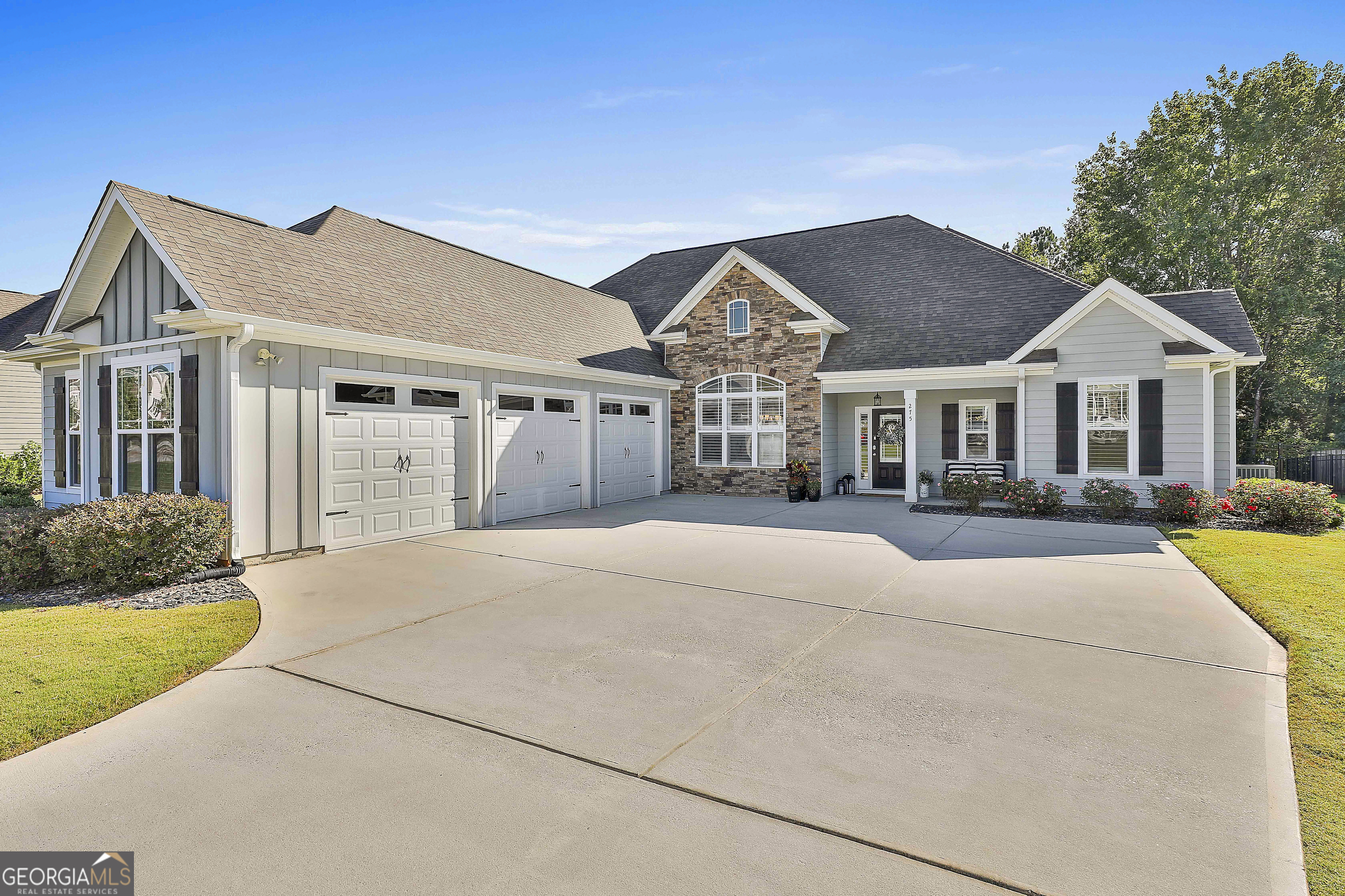 Absolutely beautiful home within a golf cart ride of downtown Senoia! Stunningly decorated and perfectly maintained! Entering the home you're enveloped into an open concept living space with high ceilings, gleaming floors and custom plantation shutters on a huge picture window. The dining room boasts coffered ceilings and the great room ceilings are vaulted. The kitchen has plenty of cabinetry and closets. The owners suite features two huge closets with built in organizers a walk in shower, separate deep tub and separate water closet. The split bedroom plan provides two generously sized bedrooms both featuring walk in closets and a full bath. The laundry room is located on the main floor. The upstairs provides two additional bedrooms with large closets, a full bath and easy access to the systems with a walk in attic space. The 3 car garage is meticulous! The floors have been finished and the space will delight every car enthusiast. From the kitchen you will enter a delightful outdoor living room featuring a wood burning fireplace and an expanded patio deck complete with a gas line hook up for the outdoor chef. The yard has a black aluminum fence with a small dog feature so even the smallest of man's best friends can play securely outside.