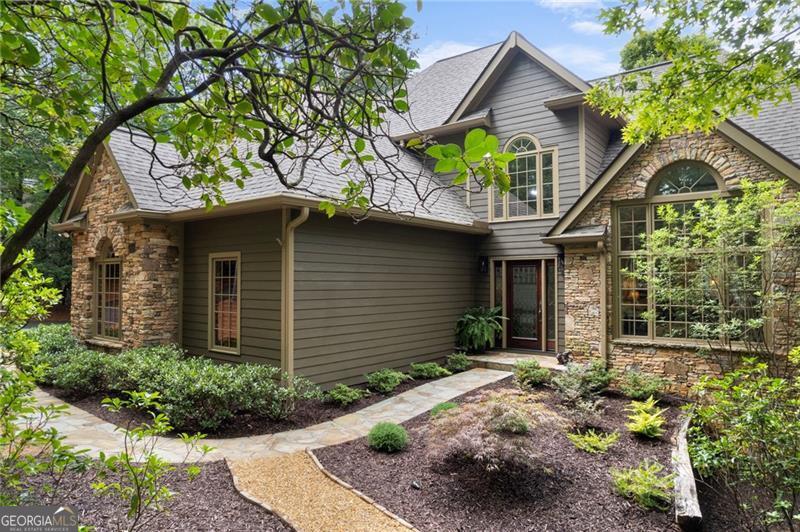 Extensively renovated 3,900 square foot craftsman style home with 4 bedrooms & 4 1/2 baths. The home is located on a large private lot in the desirable High Gap area of Big Canoe. The main floor of the home is open, filled with natural light and has newly refinished solid oak floors and fresh paint. Enjoy time in the family room with the stacked stone fireplace or in the sunroom with views of the hardwood forest and mountain laurel. The large kitchen has all new appliances, range hood, hard marble countertops, and subway tile backsplash. The dining room is just off the kitchen for hosting dinners with family & friends. The master bedroom suite is also on the main level with a beautiful tray ceiling, spacious totally renovated bath, walk-in closet and private access to the expansive deck. Upstairs offers a suite of 2 bedrooms and a full bath along with a large loft that is open to the living areas below. The terrace level includes a large family room for relaxing and enjoying a movie or ballgame. There also is another large bedroom that could be used as a craft room, exercise space, etc and a separate office with a private bathroom. In addition, the terrace level provides ample storage space. The deck and stone patio provides wonderful outdoor living and the opportunity to enjoy nature and wildlife. The home has extensive renovations including a roof, lightning protection system, hvac, tankless hot water heater, interior and exterior paint, kitchen appliances, upgraded lighting fixtures, landscaping, etc. This is a must see home to start enjoying the Big Canoe Life! Buyer to verify all information and dimensions deemed important.