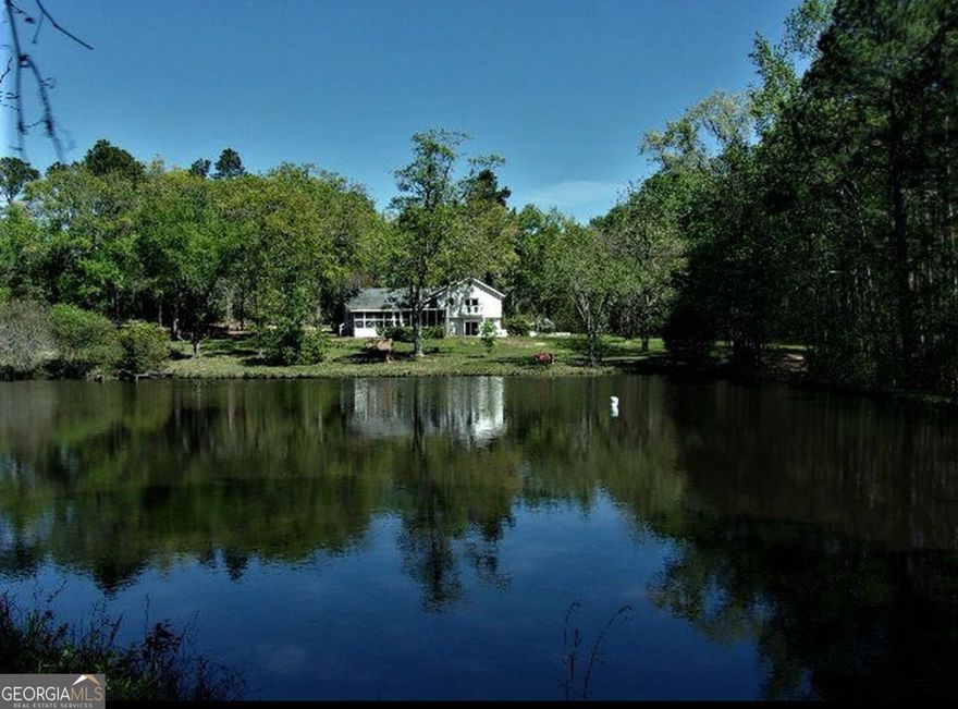 Photos are scheduled for Wednesday, June 11, 2025.  This truly unique property is perfect for those who appreciate country living, outdoor recreation, and privacy. Situated on 17 acres spanning two parcels (5 12 6 and 5 12 7), this home offers ample space and exceptional features both inside and out.    The former screened-in porch has been fully renovated into a versatile bonus room equipped with heating and air conditioning, providing year-round comfort and added living space. From this elevated vantage point, enjoy scenic views of a private pond stocked with bass, bream, and speckled perch-an ideal setting for any angler.    Additional features include:   * Two deep wells and two septic systems   * Abundant wildlife and prime hunting grounds   * Financing options: Cash, Conventional, USDA, and VA loans accepted    Main Level Highlights:   * Generously sized living room, perfect for entertaining    Upper Level:   * Expansive primary suite with a private balcony overlooking the pond   * En suite bathroom featuring a second walk-in closet   * Two additional bedrooms and a full bathroom    Lower Level:   * Two more bedrooms   * Walk-in closet   * Full bathroom   * Laundry room   * French doors offering beautiful pond views    Whether you're looking for a private retreat or a homestead with room to roam, this property delivers a rare blend of comfort and rural charm.