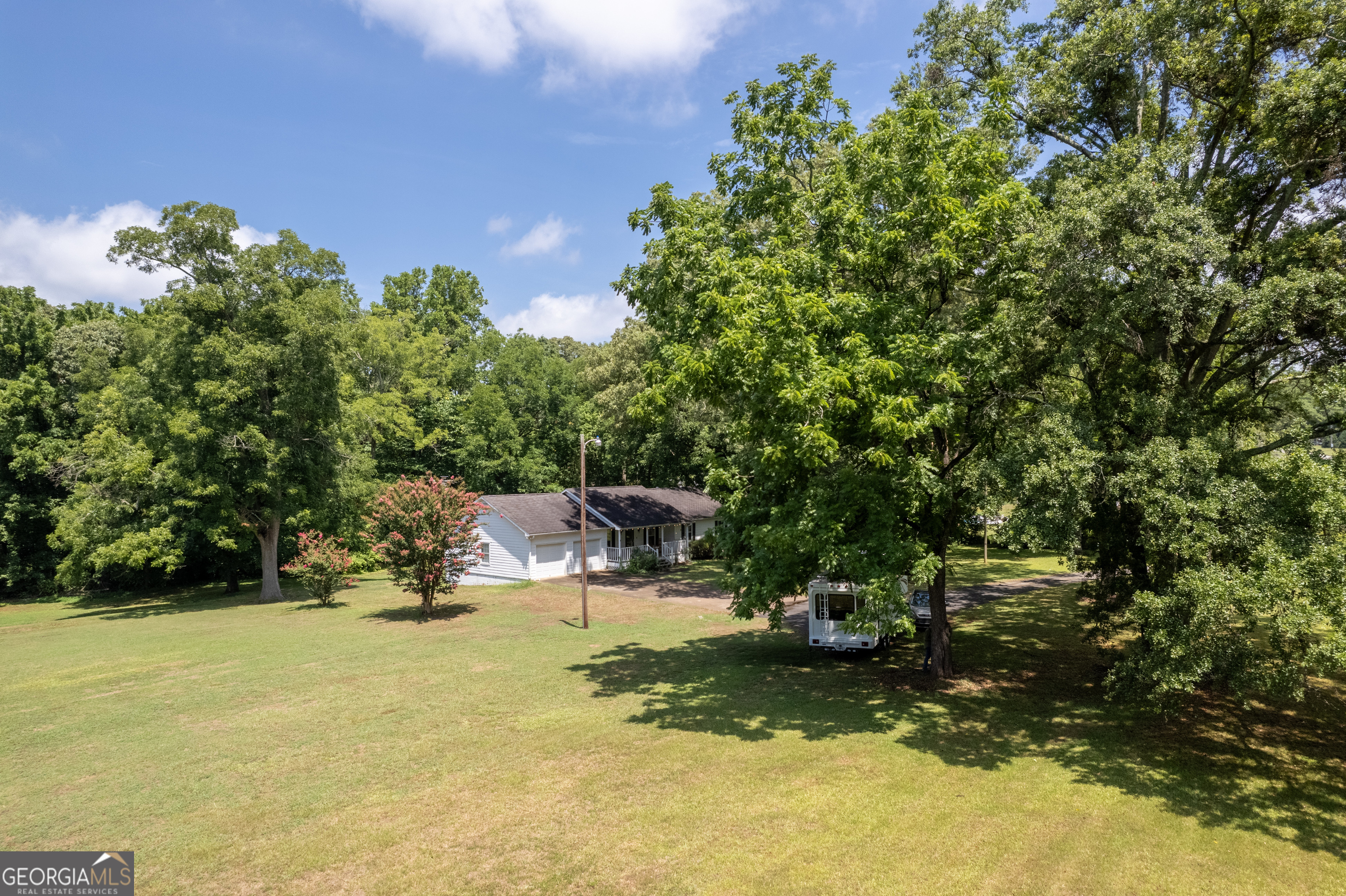 Well-Maintained Ranch House with Rocking Chair Front Porch on 3.7 Acres. Nestled in prime West Cobb real estate, this well-maintained ranch-style home exudes charm. Picture yourself on the rocking chair front porch, savoring morning coffee or watching the sunset. Inside, you'll find 3 bedrooms, 2 baths, and an unfinished basement-a canvas for your creativity. Whether you choose to live in it as-is, renovate, or build your dream home, the 3.7-acre lot offers endless possibilities. Conveniently located near the West Cobb Avenues, this property provides easy access to restaurants, shopping, parks, and excellent schools. Enjoy, quick connectivity to downtown Marietta, Kennesaw Mountain, Kennesaw State University, and I-75. Lot is zoned high density residential.