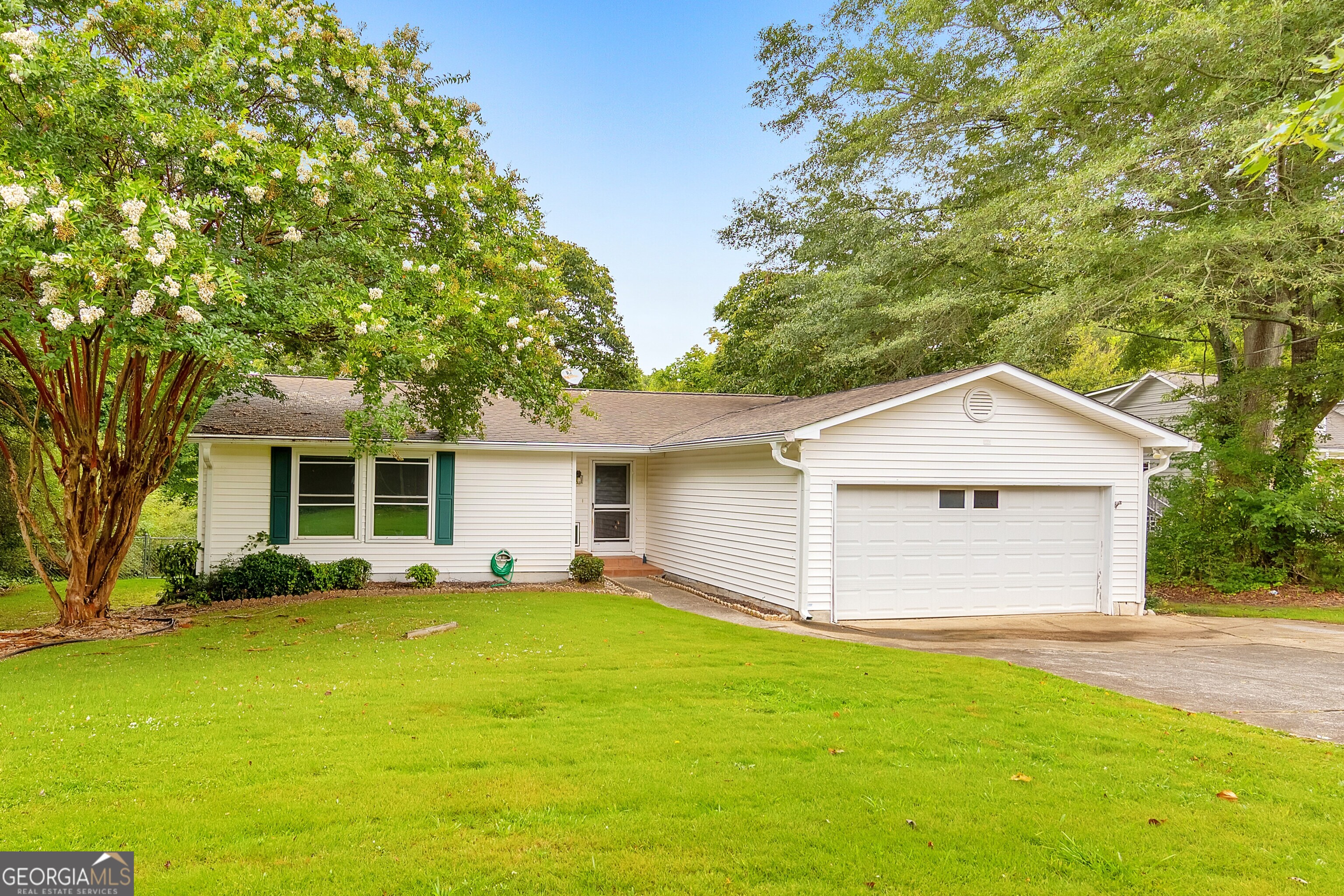 This is the one you've been waiting for! This charming 3 bed / 3 bath ranch home in the heart of East Cobb offers a brand new deck, newer carpet, and newer interior paint. The bright and airy kitchen flows seamlessly into the dining area, featuring an elegant pass-through window to the spacious living room with soaring ceilings, a wet bar closet, and a cozy stone fireplace. Unwind in the inviting sunroom that is perfect for morning coffee or reading a good book. This room could also be used as a third or fouth bedroom. Each bedroom enjoys its own private bath, while the primary suite boasts a large walk-in closet and an ensuite featuring dual vanities and a whirlpool tub. Step outside to a generous new deck overlooking the fenced backyard, and take advantage of the additional 3rd garage for extra storage space. Nestled in the sought-after Sprayberry High School district, with shopping and dining just minutes away!
