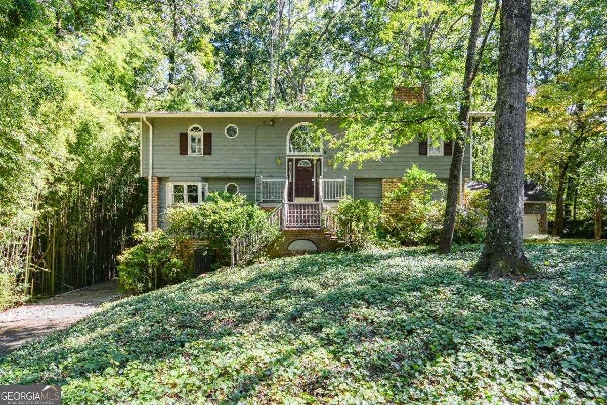 Nestled within the City Limits of Marietta, this meticulously crafted custom home offers an exceptional living experience. Situated on a private one-acre lot, it provides both tranquility and space for outdoor enjoyment. The quality craftsmanship is evident throughout, with recent upgrades including a new roof, gutters, and a newer HVAC system. Inside, the home boasts three bedrooms, three full baths, and an office/bonus room-a layout that accommodates families and guests alike. The great room features a cozy fireplace with gas logs, while the formal dining room and eat-in kitchen (complete with custom cabinets, granite countertops, and ceramic tile flooring) cater to both everyday living and entertainment. Real hardwood floors grace the additional levels, adding warmth and elegance. The luxurious primary bedroom suite beckons with vanity, a separate shower, and a walk-in Jacuzzi tub-a true retreat. Practical elements include a practically finished basement room with a brick fireplace, a workshop, and ample storage. The detached three-car garage, complete with attic storage, ensures convenience. And for peace of mind, a full house generator stands ready to provide uninterrupted comfort. Whether you're drawn to the location, the thoughtful design, or the serene surroundings, this Marietta gem awaits its fortunate new owner. ??