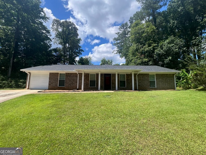 This beautifully renovated 3-bedroom, 2-bath ranch is move-in ready and packed with modern upgrades. Step into the oversized family room featuring built-in bookshelves and luxury vinyl plank flooring that flows throughout the main living areas. The brand-new kitchen showcases quartz countertops, a tile backsplash, all-new cabinetry, stainless steel appliances, and a breakfast bar-perfect for everyday living or entertaining. A separate dining room provides a more formal space for meals. The spacious master bedroom includes an adjustable closet shelving system and a sleek, tiled en-suite bath. Both guest bedrooms are generously sized and also feature custom adjustable closet shelving. The stylish hall bath is fully tiled and updated. Additional highlights include a functional mud room with seating, a laundry closet, a single-car garage with automatic opener, and additional driveway parking. Enjoy outdoor living on the rocking chair front porch or private rear patio overlooking the fenced backyard. Move in Ready with renovations including new LVP flooring in main living areas, new carpet in bedrooms, all new kitchen cabinets, quartz countertops, stainless steel appliances, fully tiled baths, mud room, and laundry area, new plumbing and light fixtures throughout and freshly painted interior. Conveniently located close to dining, shopping, entertianment and fully updated-this home checks every box!